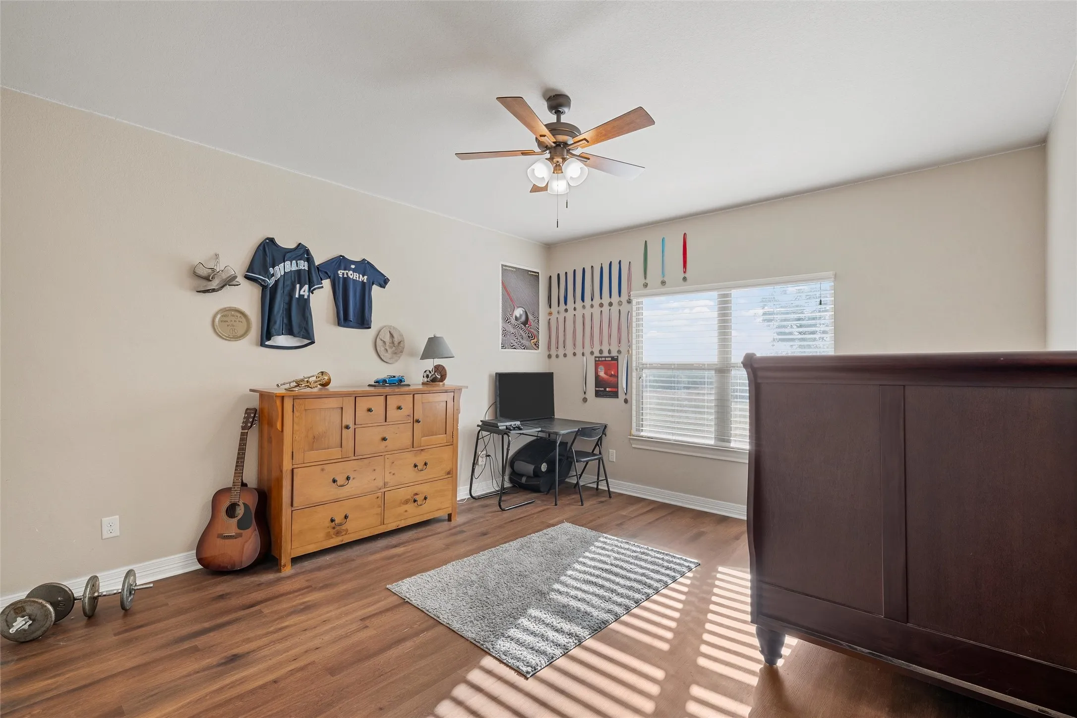Bedroom #3 featuring a desk, wood finished floors, and a ceiling fan
