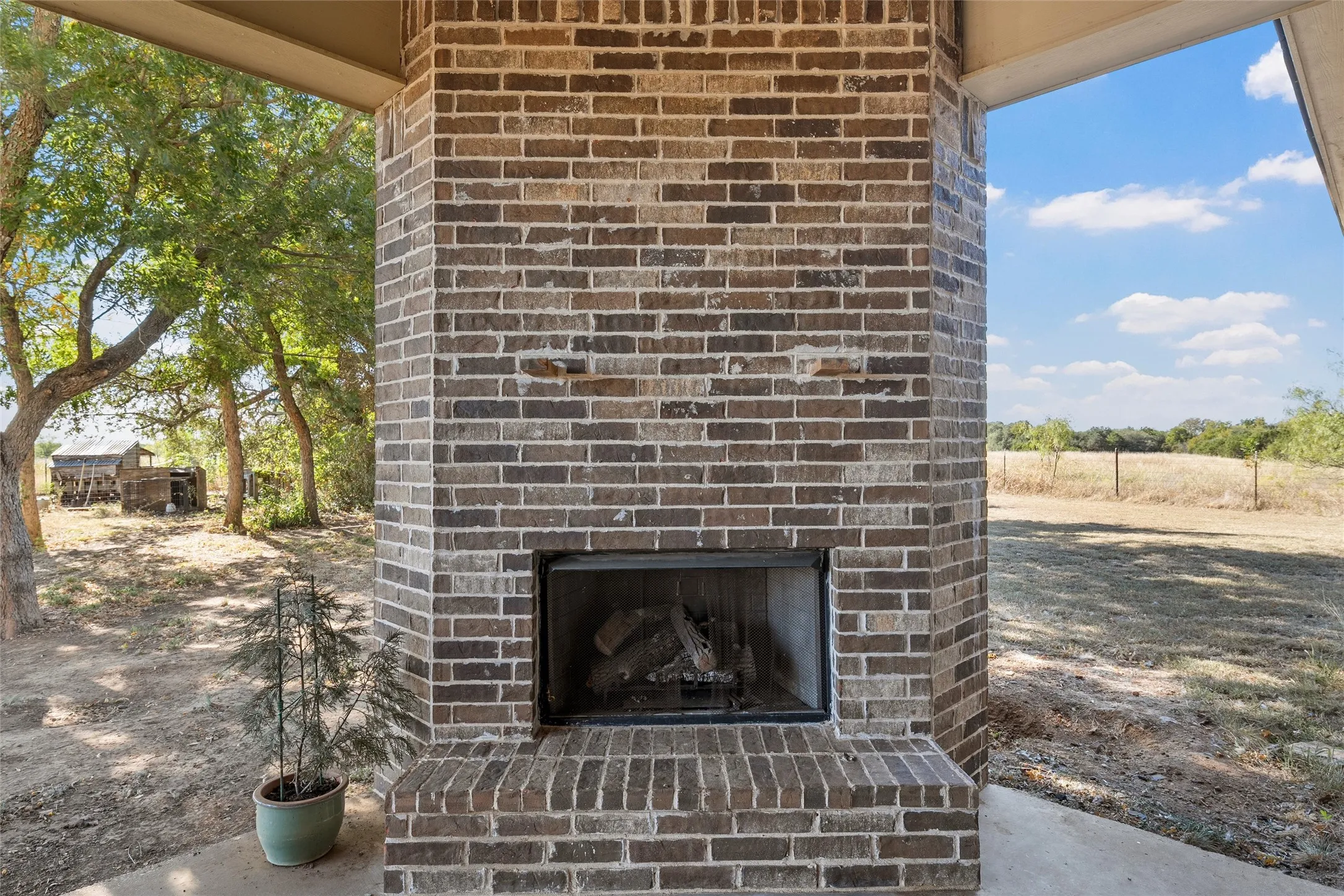 Exterior view of an outdoor brick fireplace