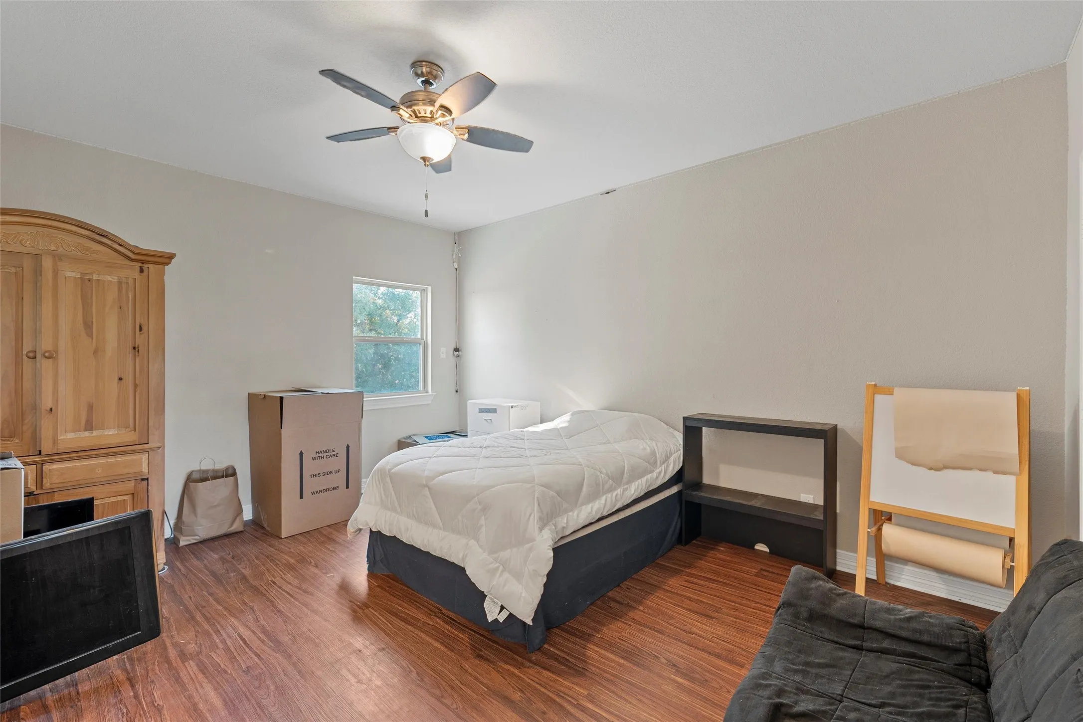 Bedroom #4 featuring wood finished floors and ceiling fan