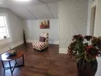 Bonus room featuring vaulted ceiling and dark wood-style floors