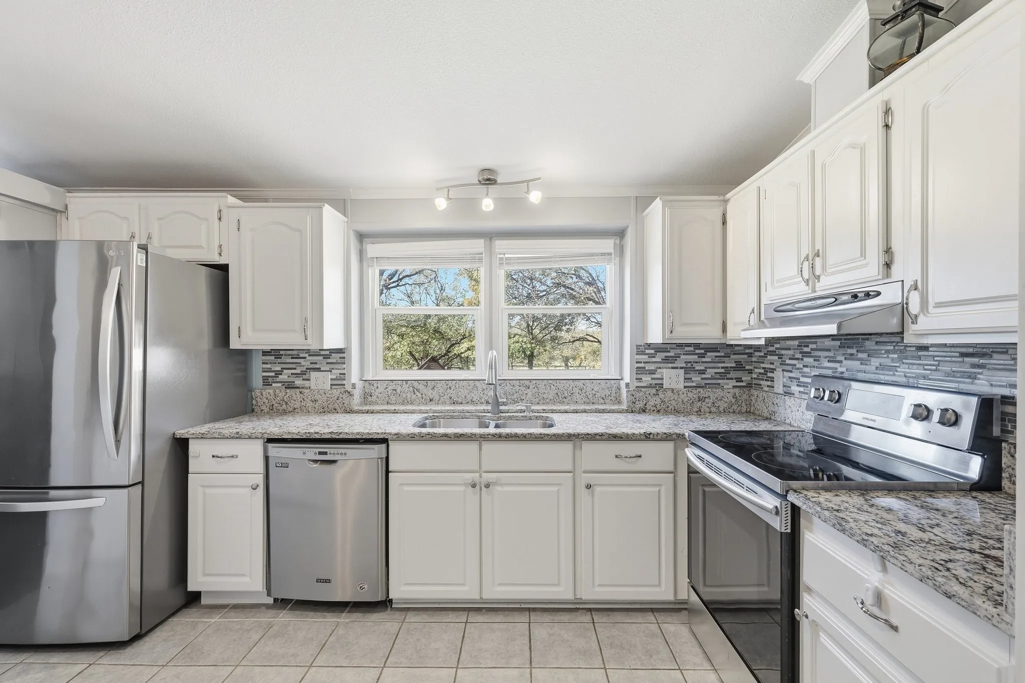 Granite Counters, Stainless Appliances, and a Wide Kitchen Window Offering Panoramic Views of this Natural Setting. Designed For Everyday Convenience with Plenty of Workspace.
