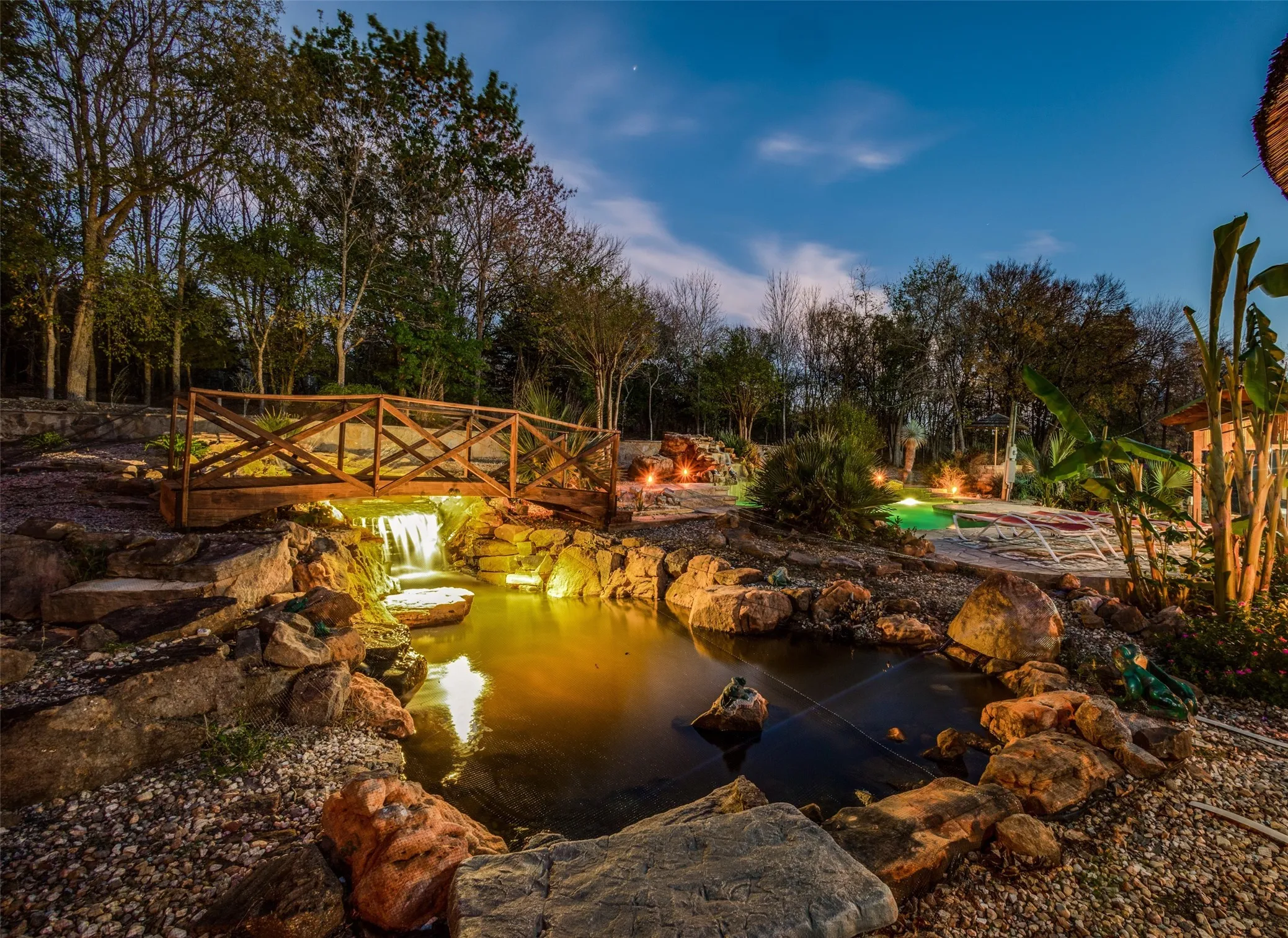 Lighted Koi Pond with Japanese Koi and High Banded Shark, African Thatched Umbrellas, and Custom Bridges Throughout. No Other Properties Nearby Will Compare!