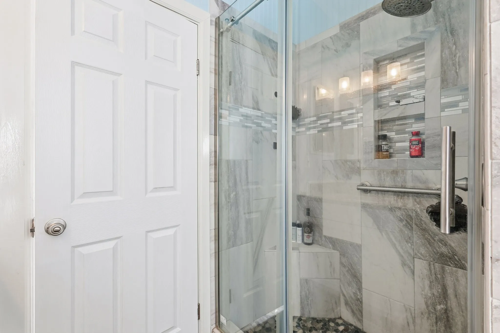 Walk-in Shower in the Primary Bathroom, Beautifully Updated with Tile Surround, Built-in Niche, and Modern Fixtures.