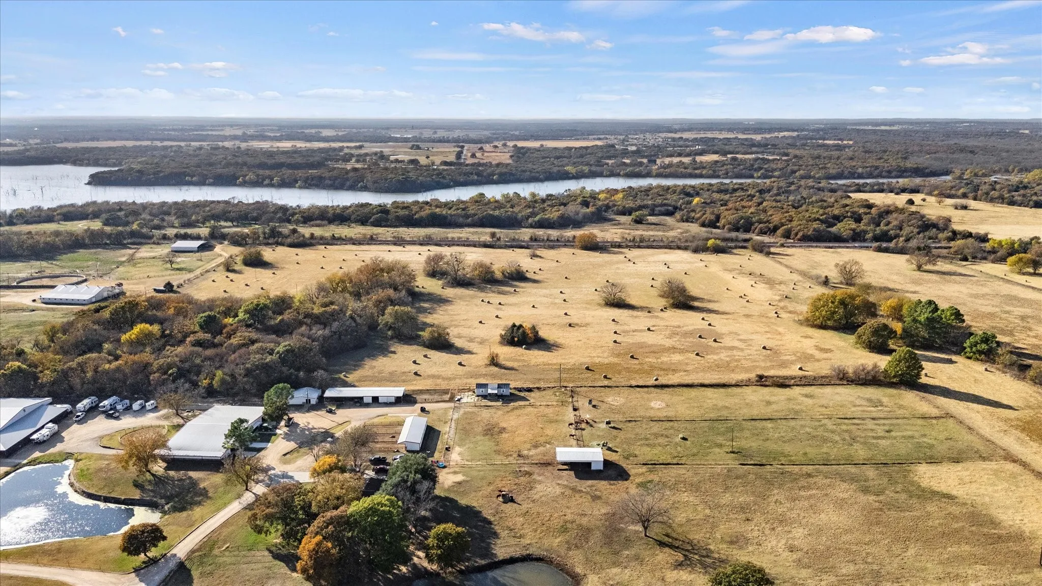 Aerial view of property and surrounding area featuring a nearby body of water