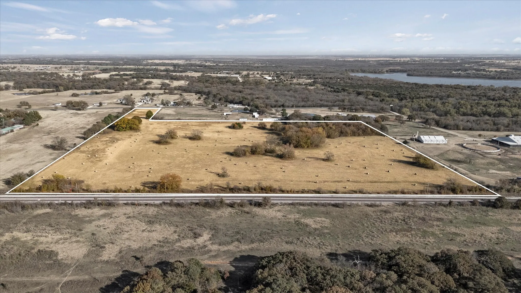 Aerial view of property's location with a nearby body of water and property boundaries highlighted