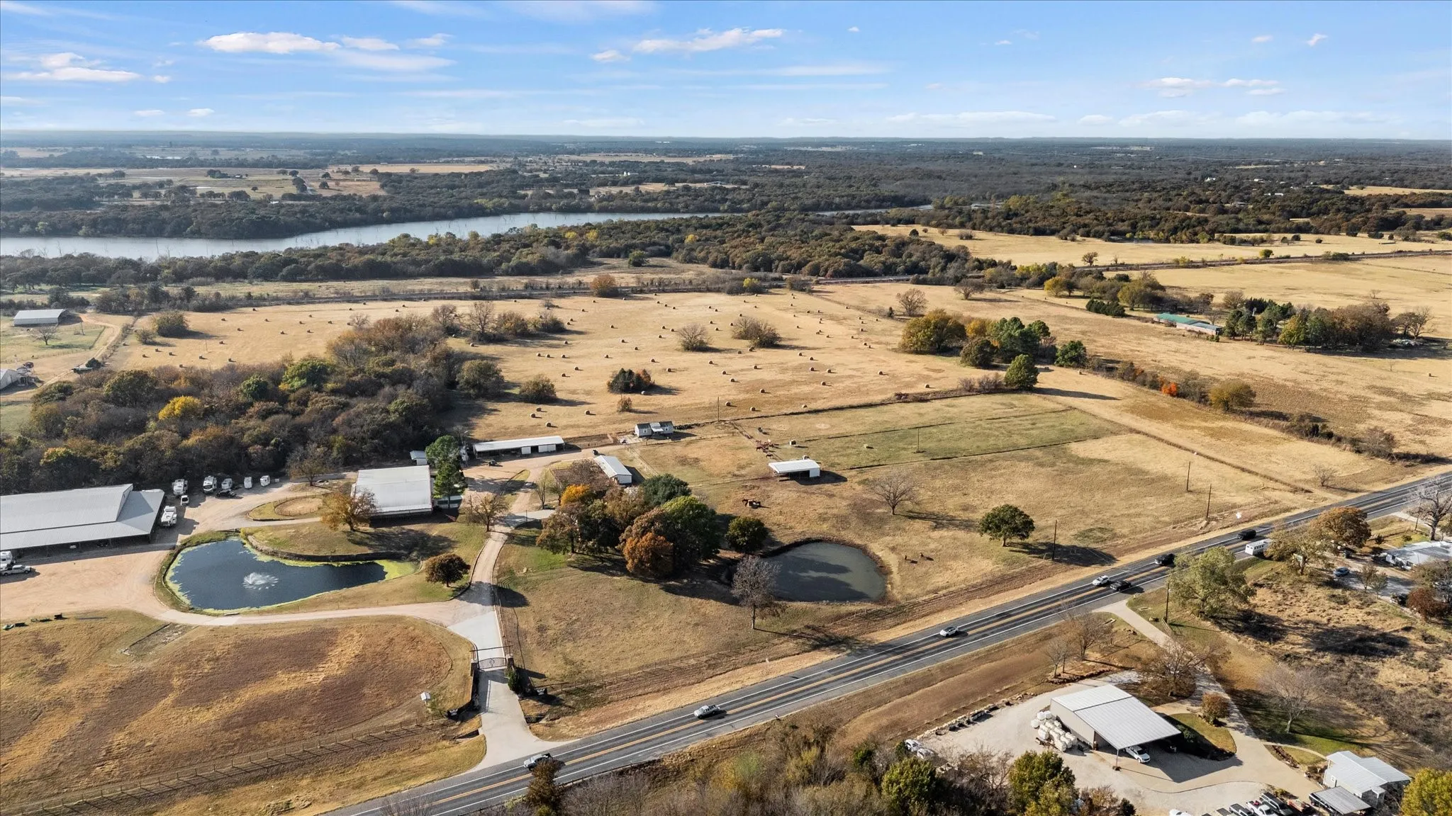 Aerial view of property and surrounding area with a nearby body of water