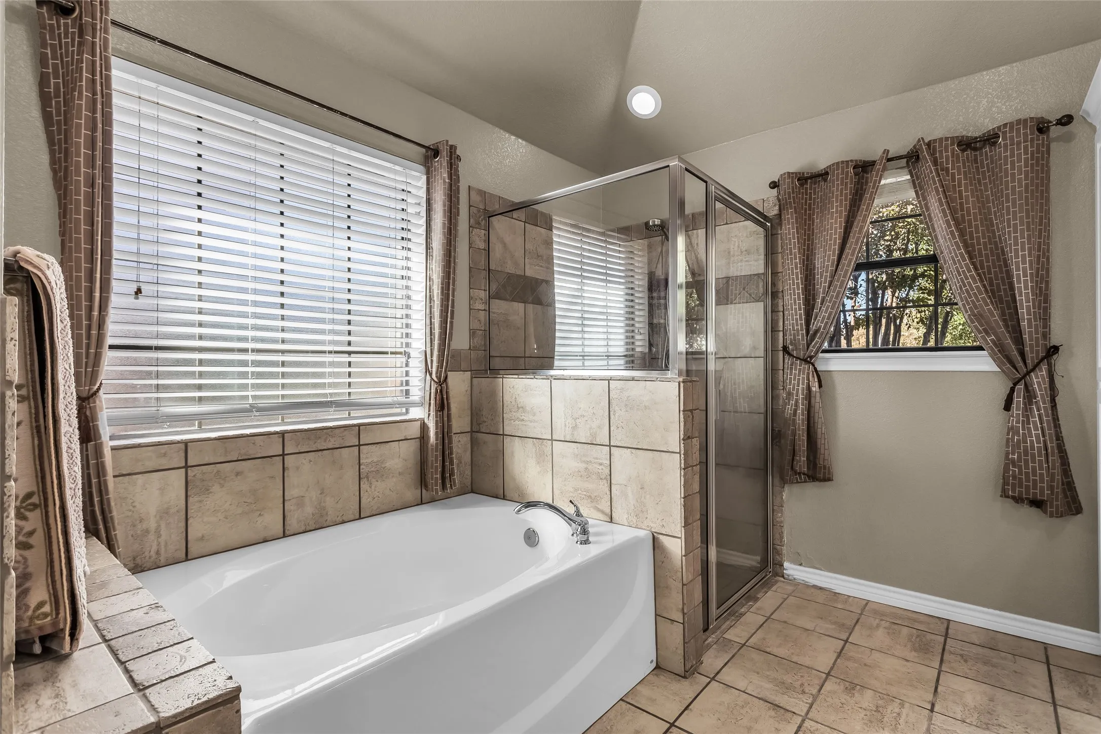 Full bath with a garden tub, light tile patterned floors, a stall shower, and recessed lighting