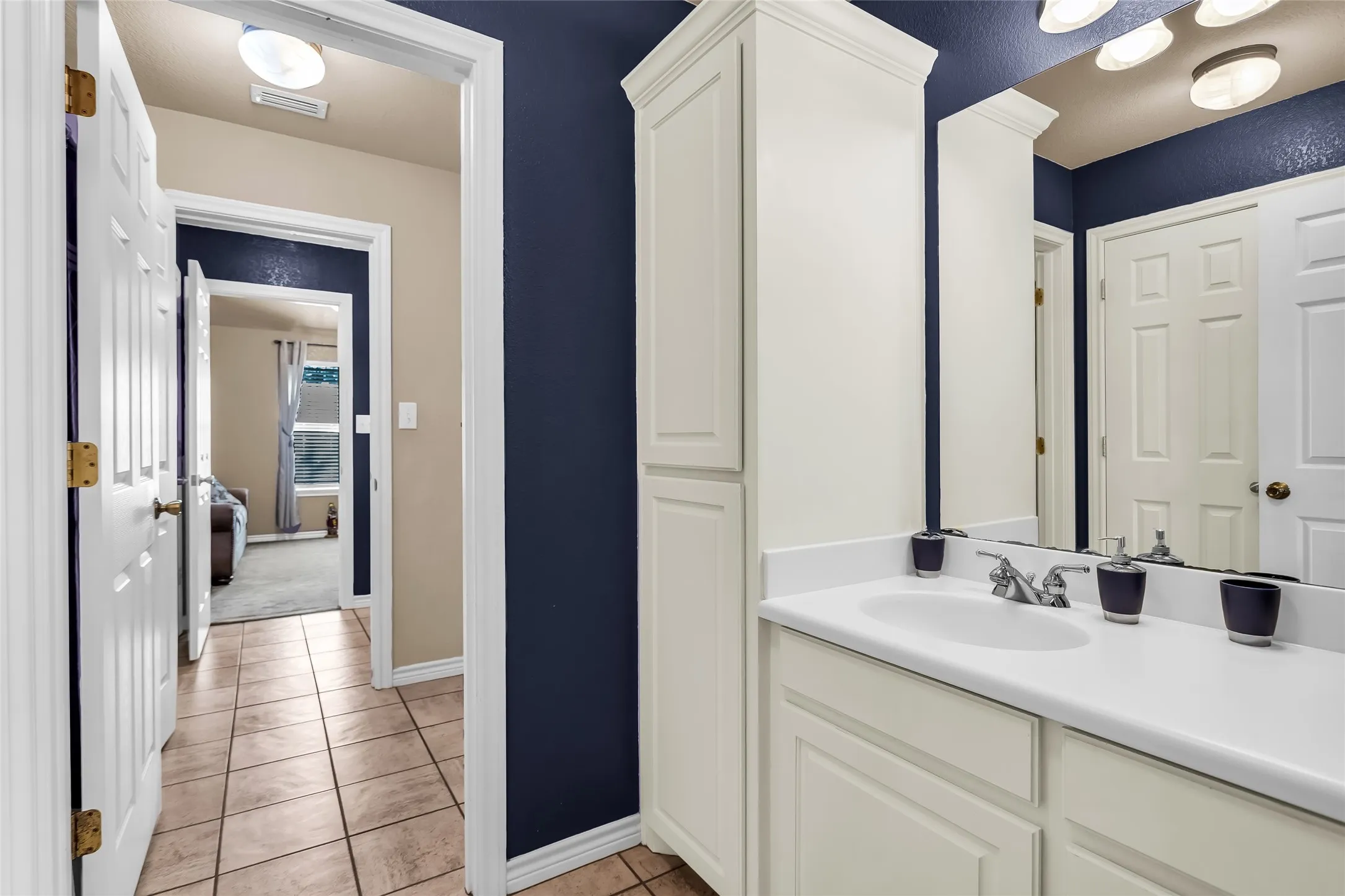 Bathroom featuring vanity and light tile patterned floors