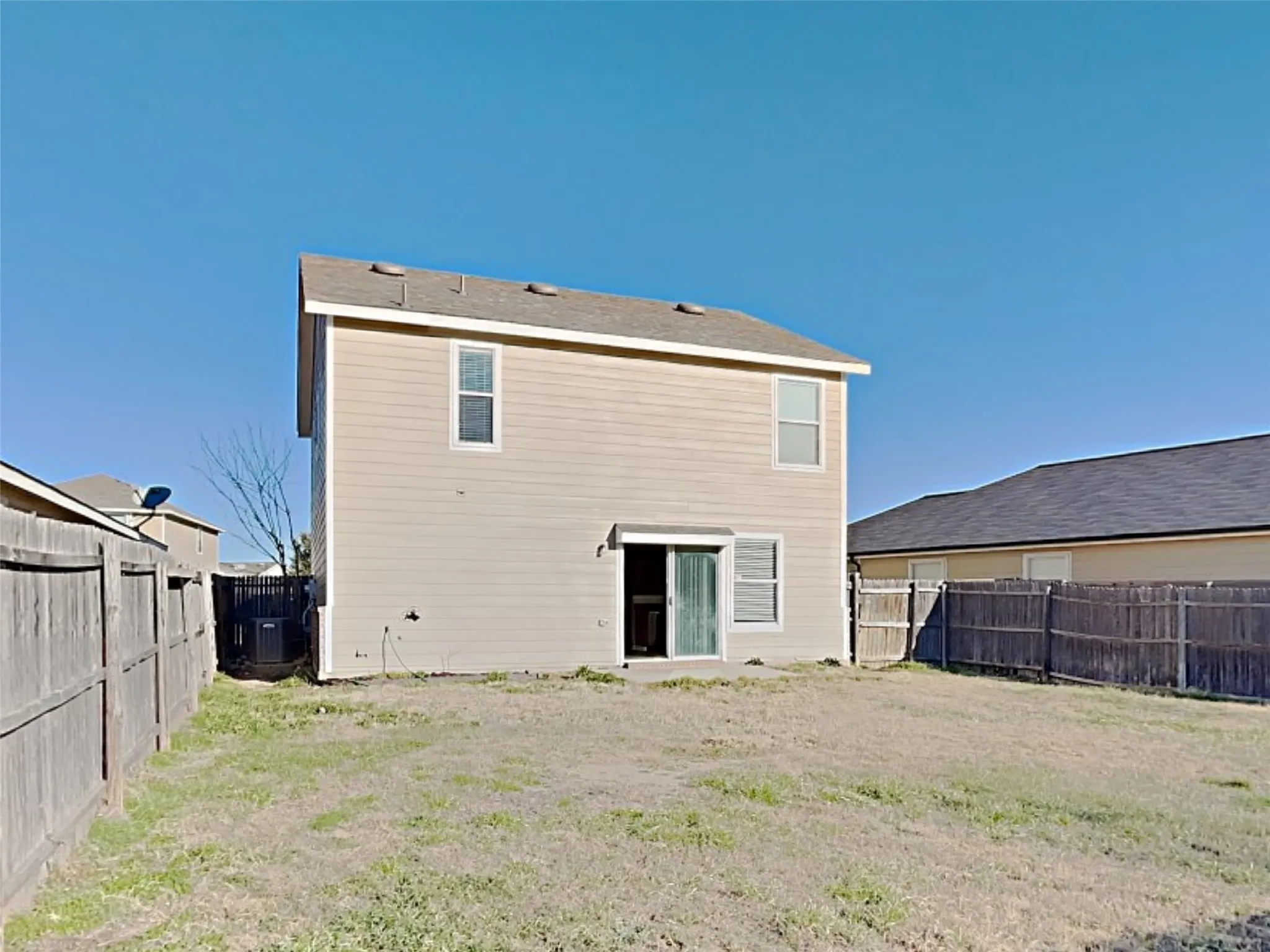 Rear view of house with a fenced backyard