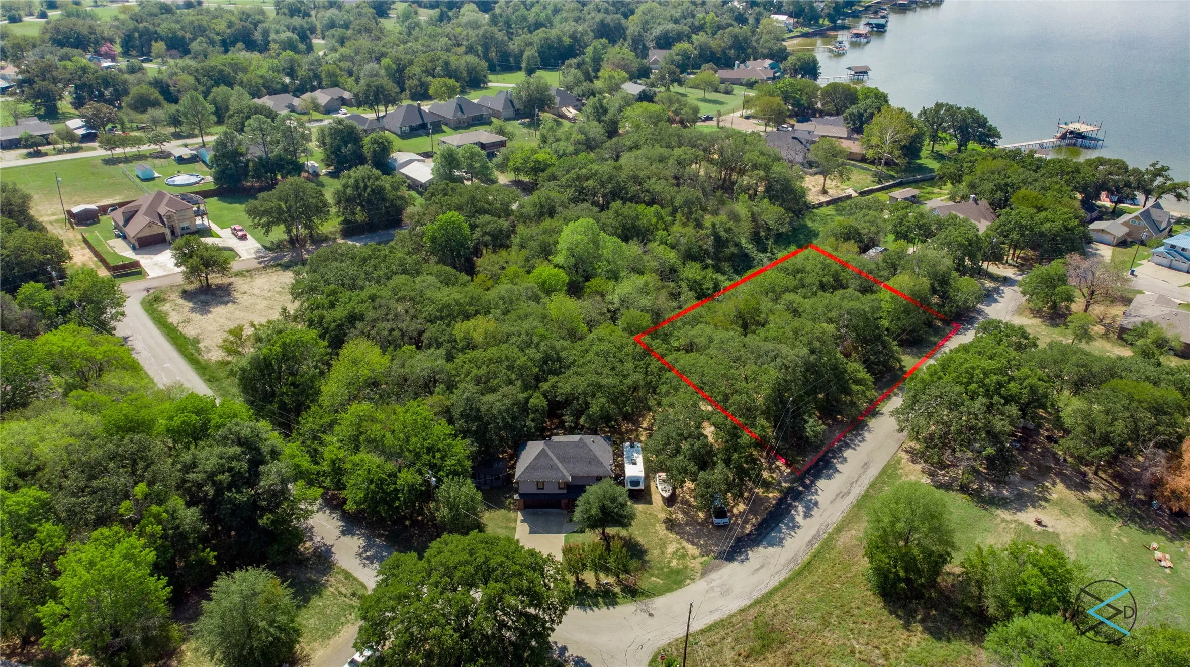 Birds eye view of property with a water view