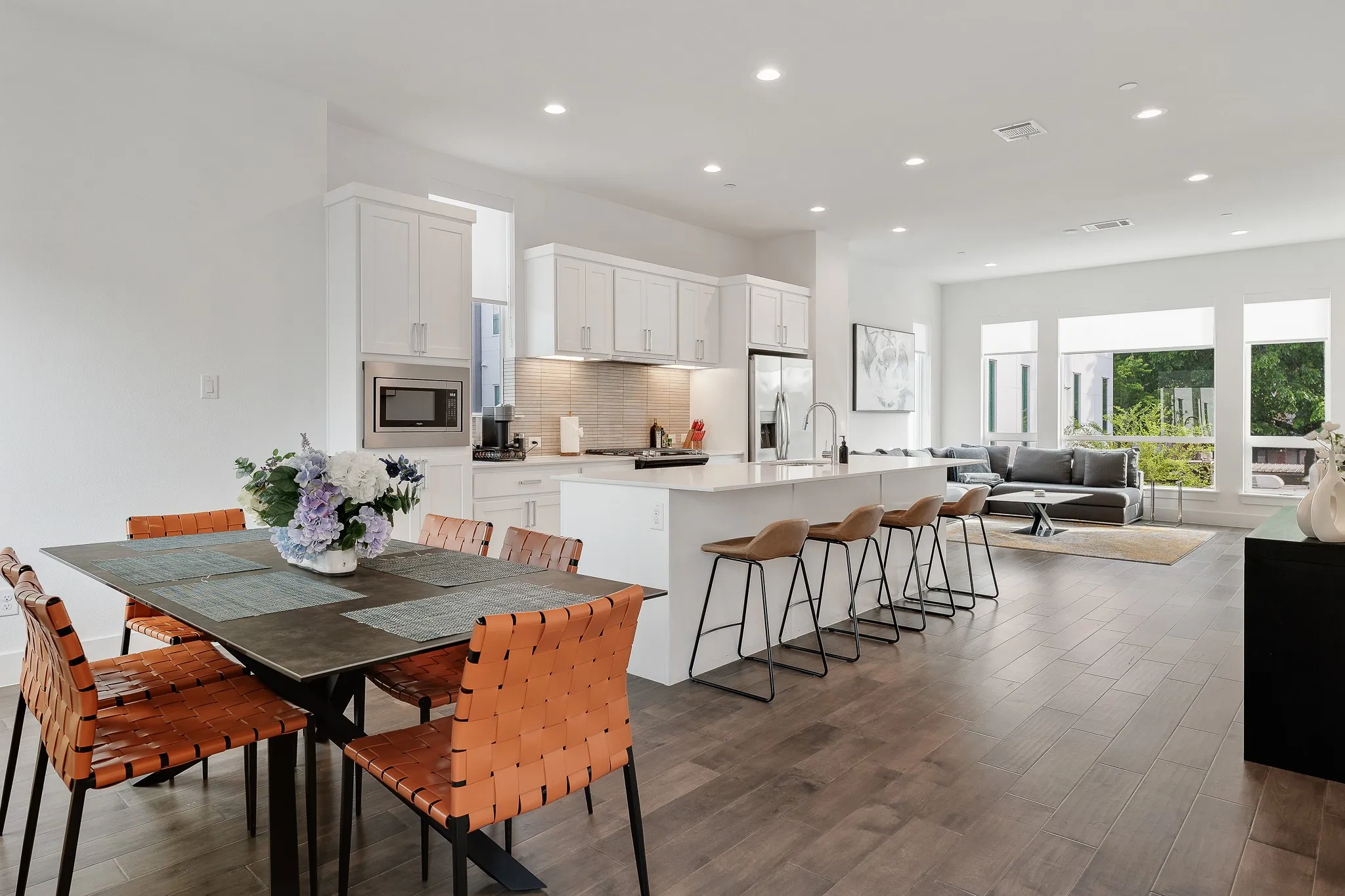 Dining room with dark wood-type flooring and recessed lighting