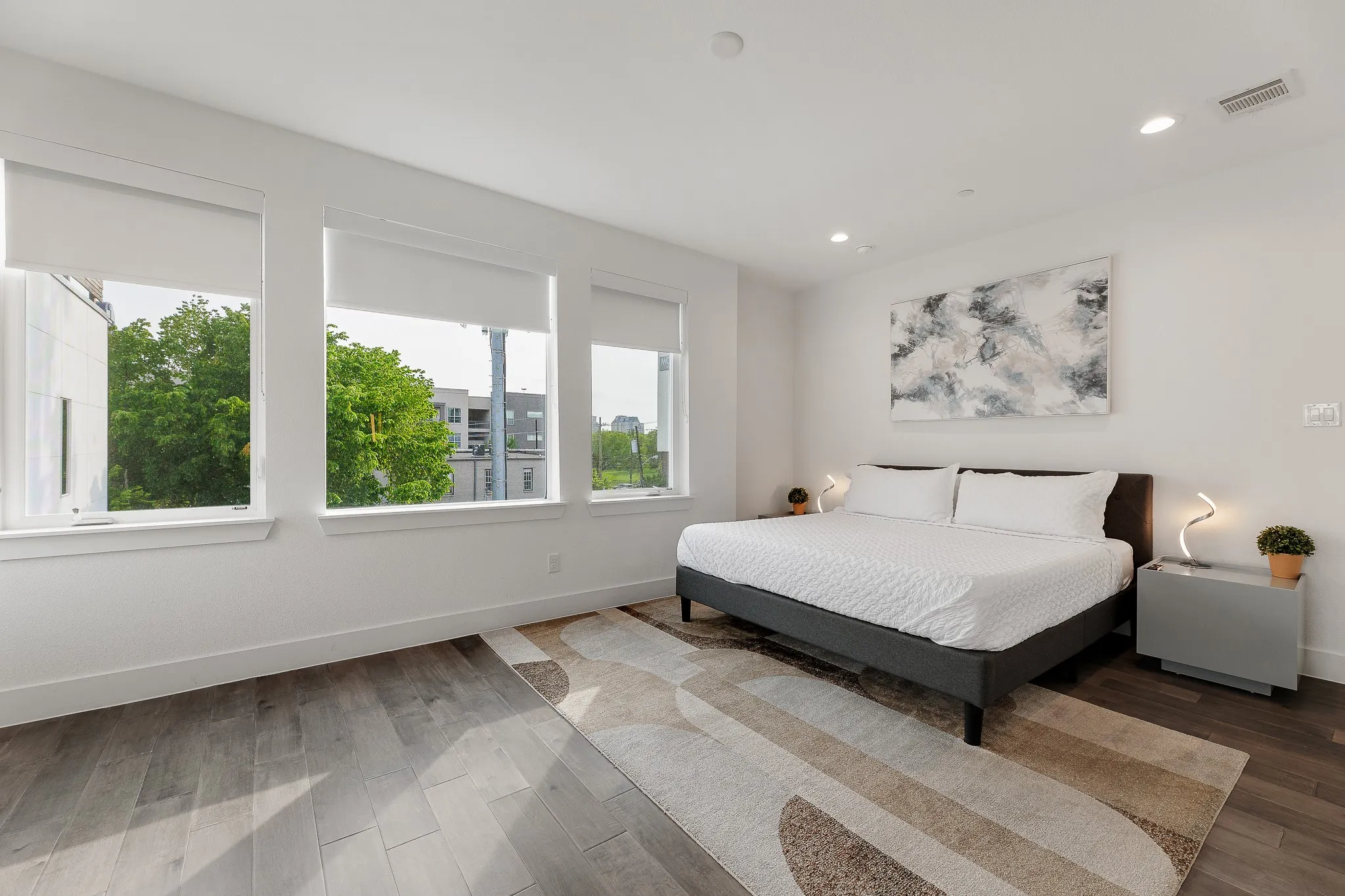 Bedroom with wood finished floors and recessed lighting