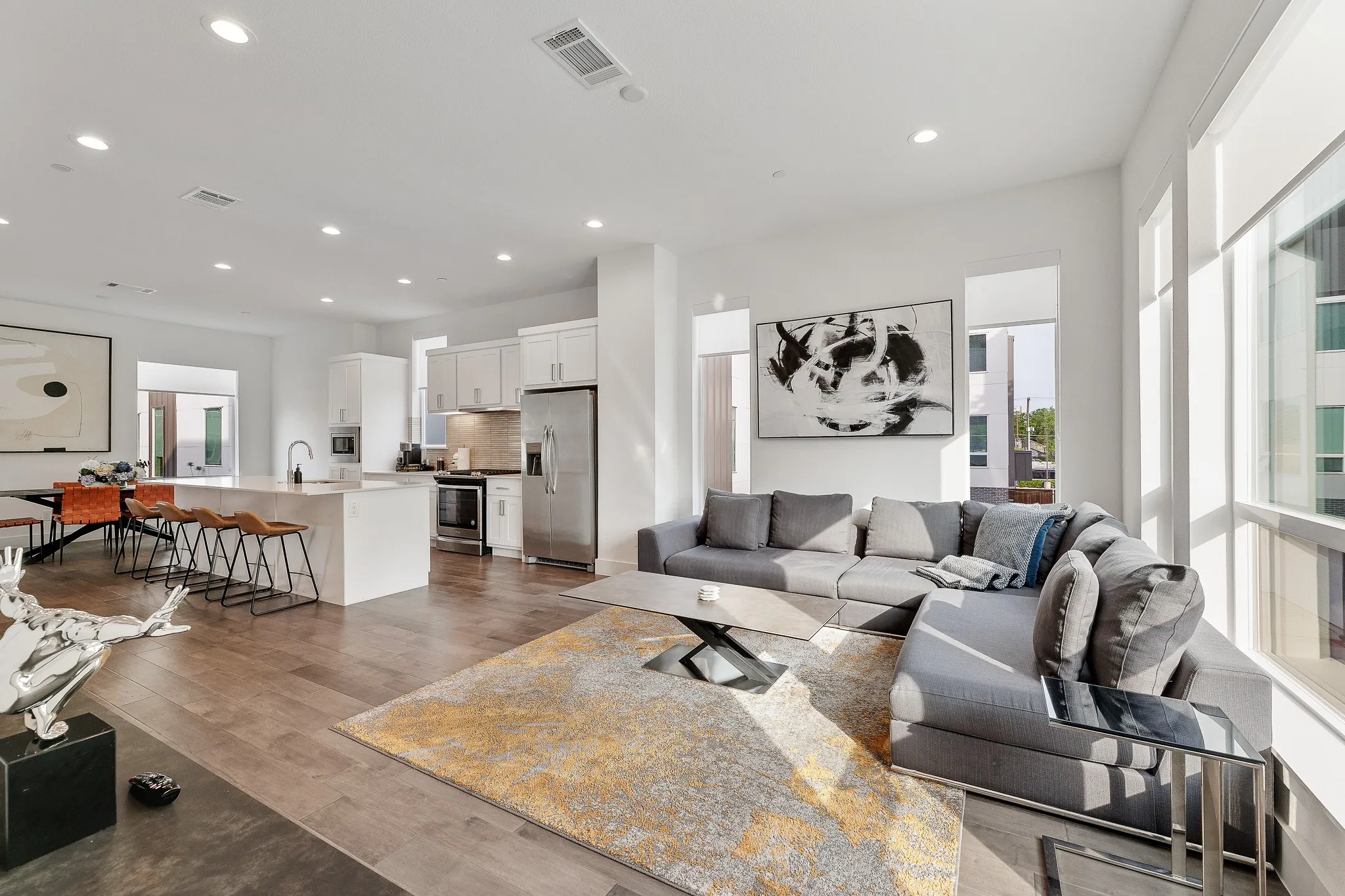 Living area with recessed lighting and dark wood-style floors