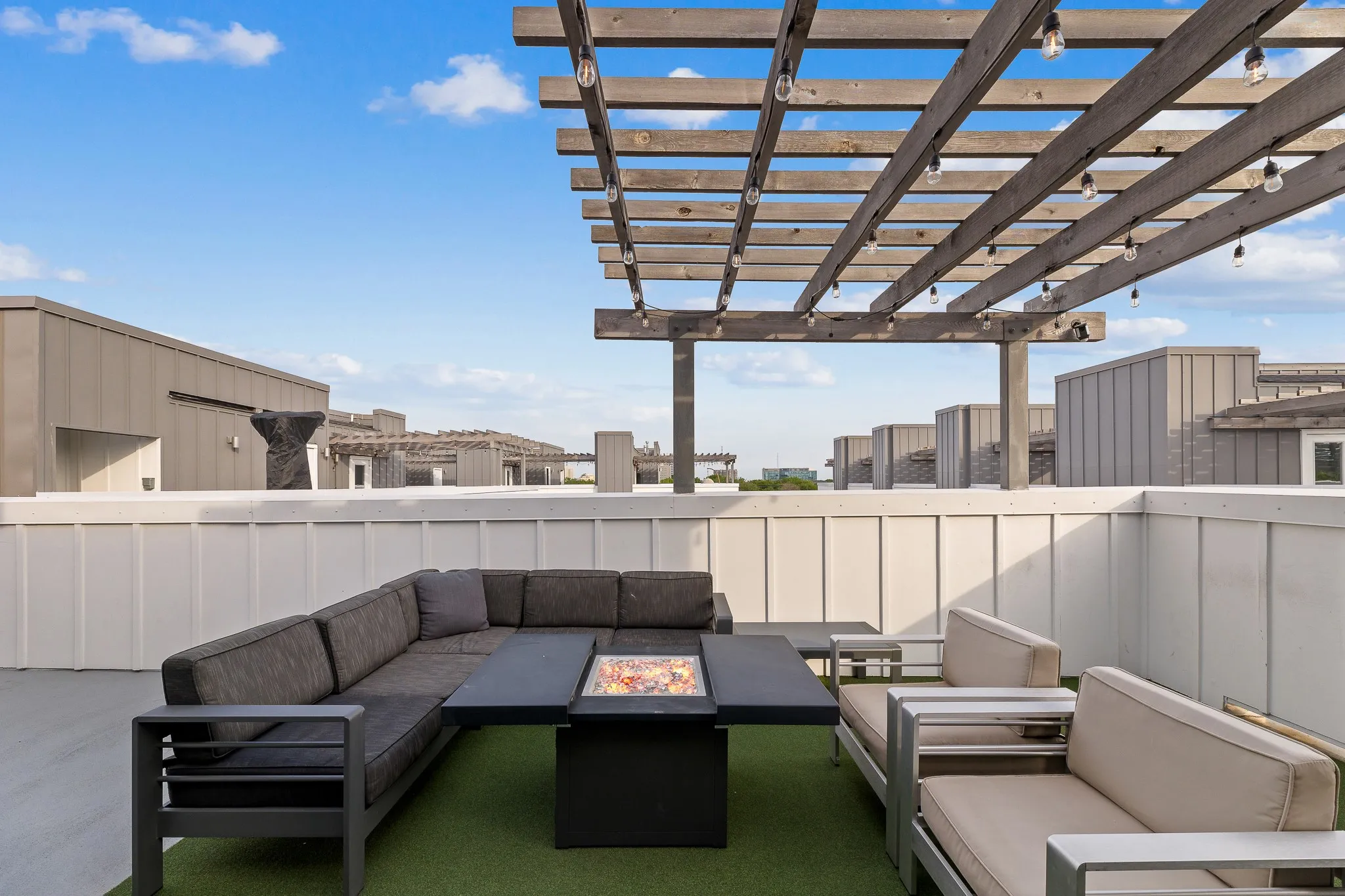 View of patio featuring an outdoor living space with a fire pit