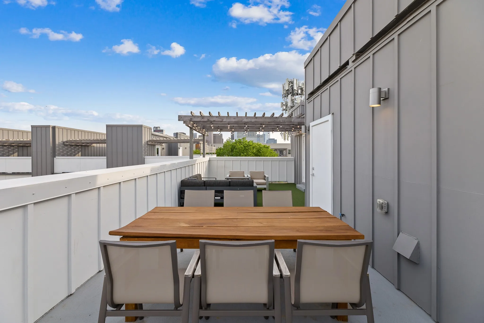Balcony featuring outdoor dining space and a pergola