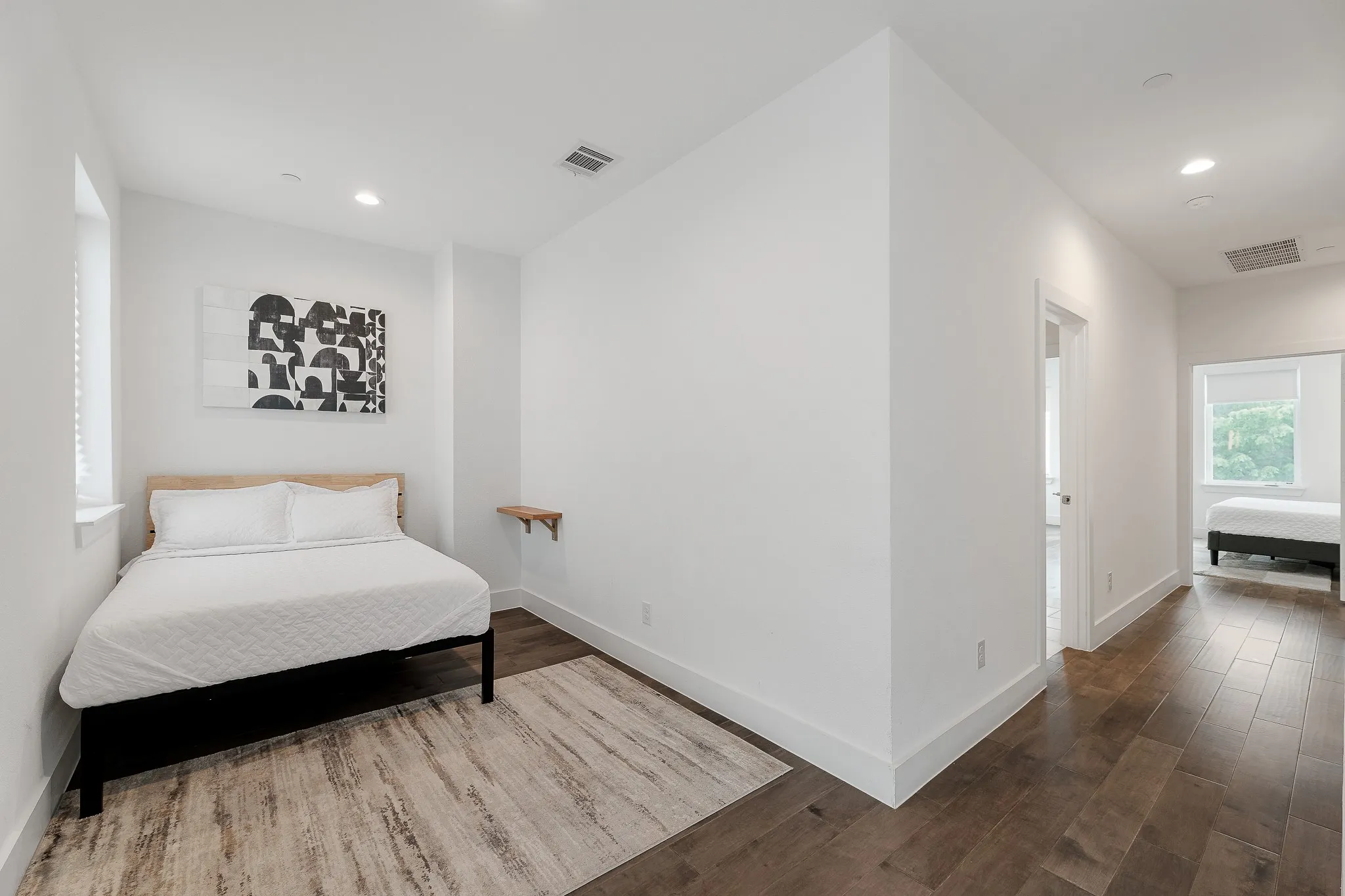 Bedroom with wood finished floors and recessed lighting