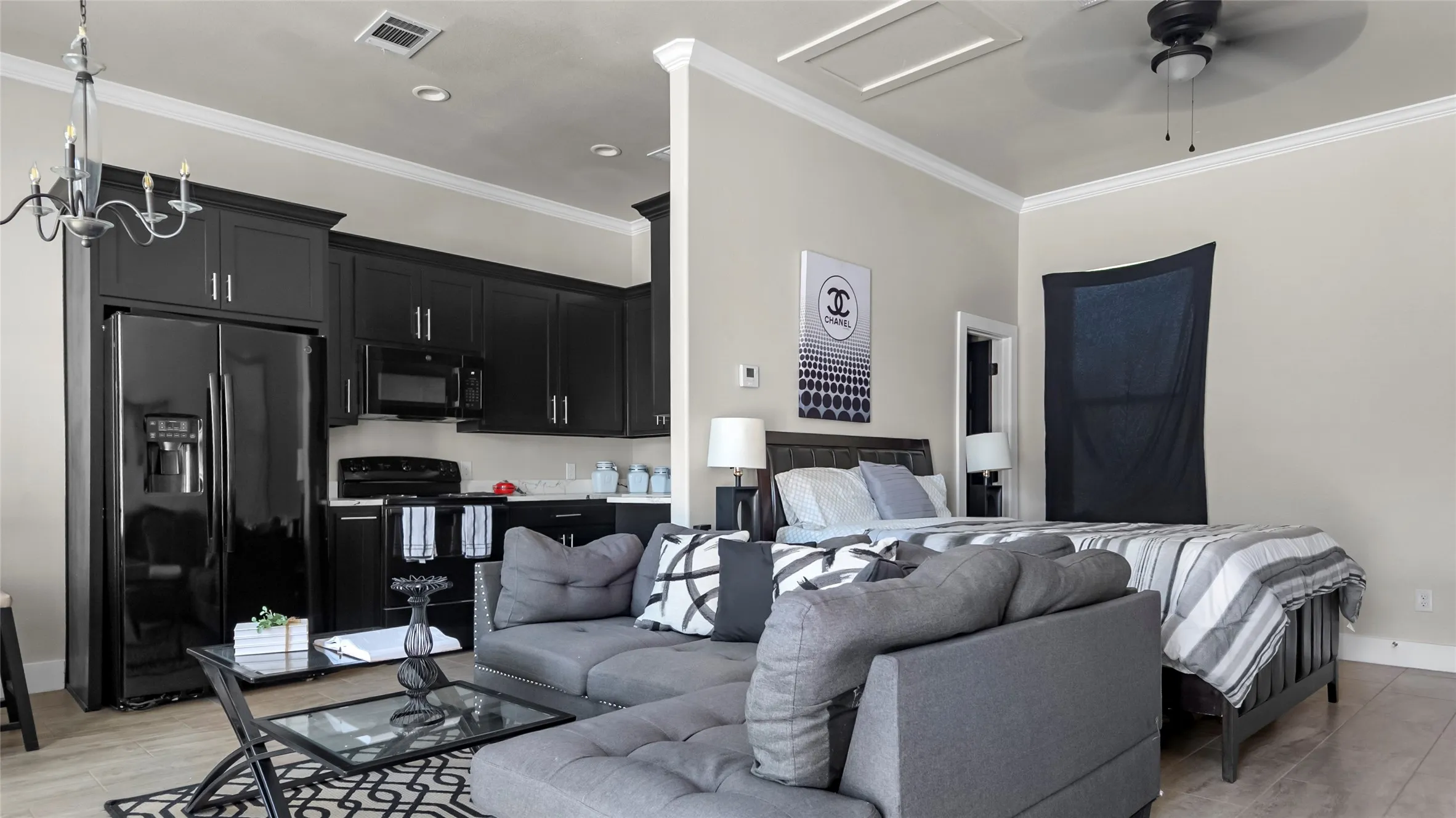 Living room with ornamental molding, a ceiling fan, recessed lighting, light wood finished floors, and a chandelier