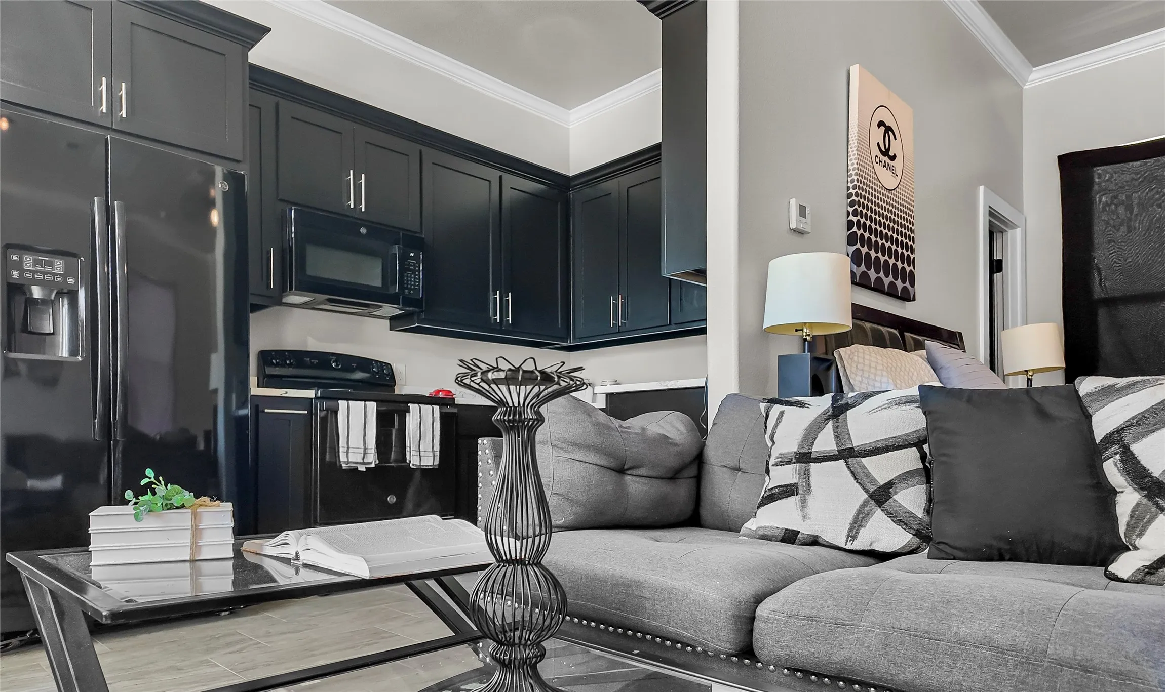 Living area with ornamental molding and light wood-style floors