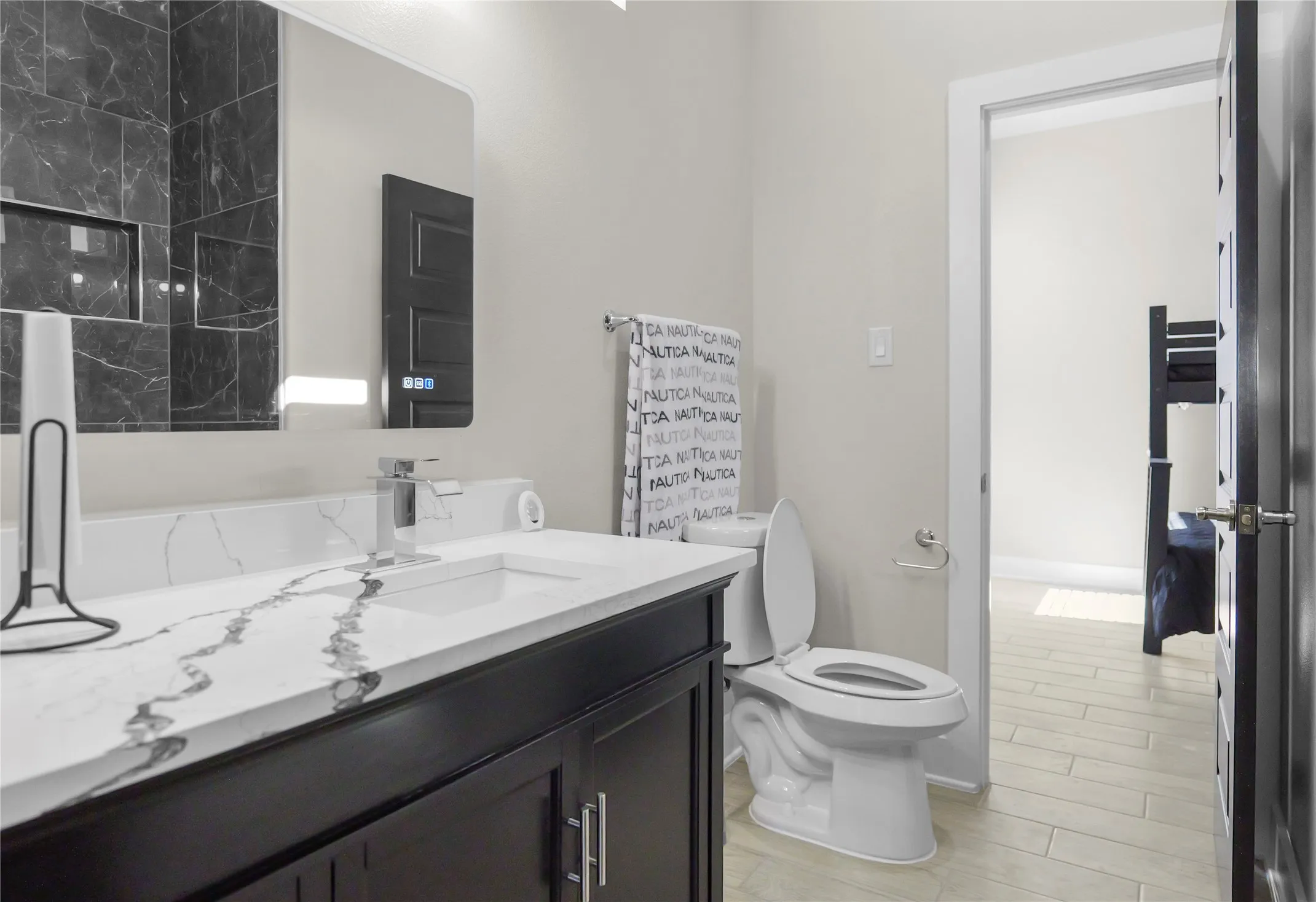 Full bathroom with vanity and wood tiled floors