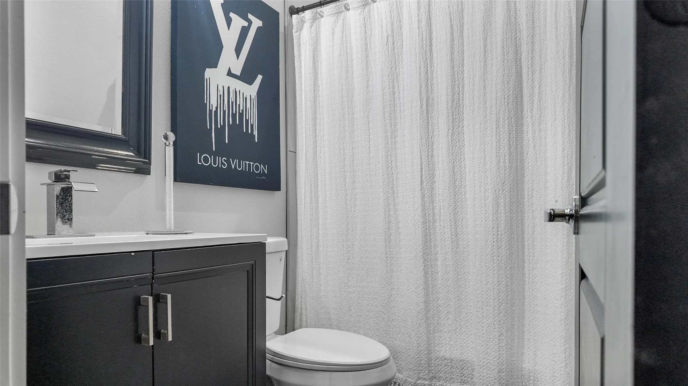 Bathroom featuring vanity and a shower with shower curtain