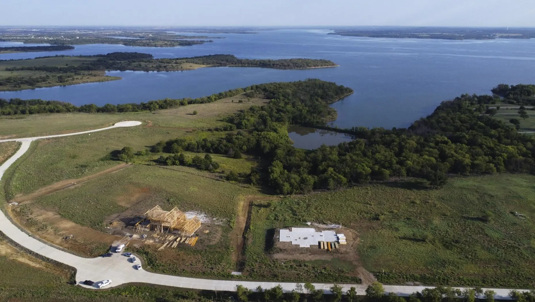 Aerial view of property and surrounding area featuring a nearby body of water