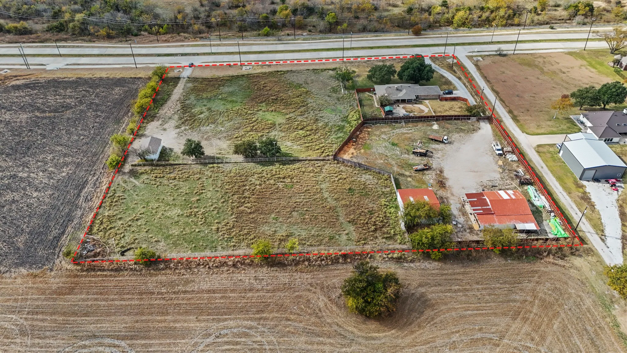 Aerial view of sparsely populated area featuring property boundaries highlighted