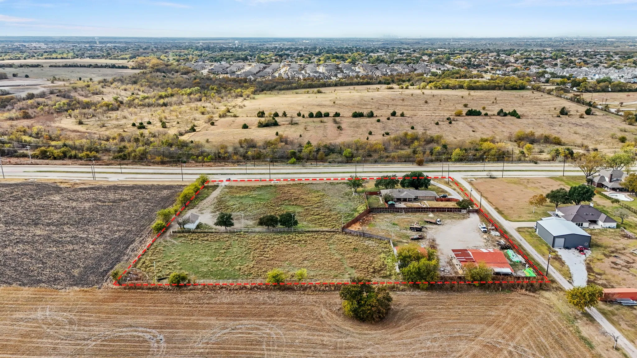 Aerial view of sparsely populated area featuring property boundaries highlighted