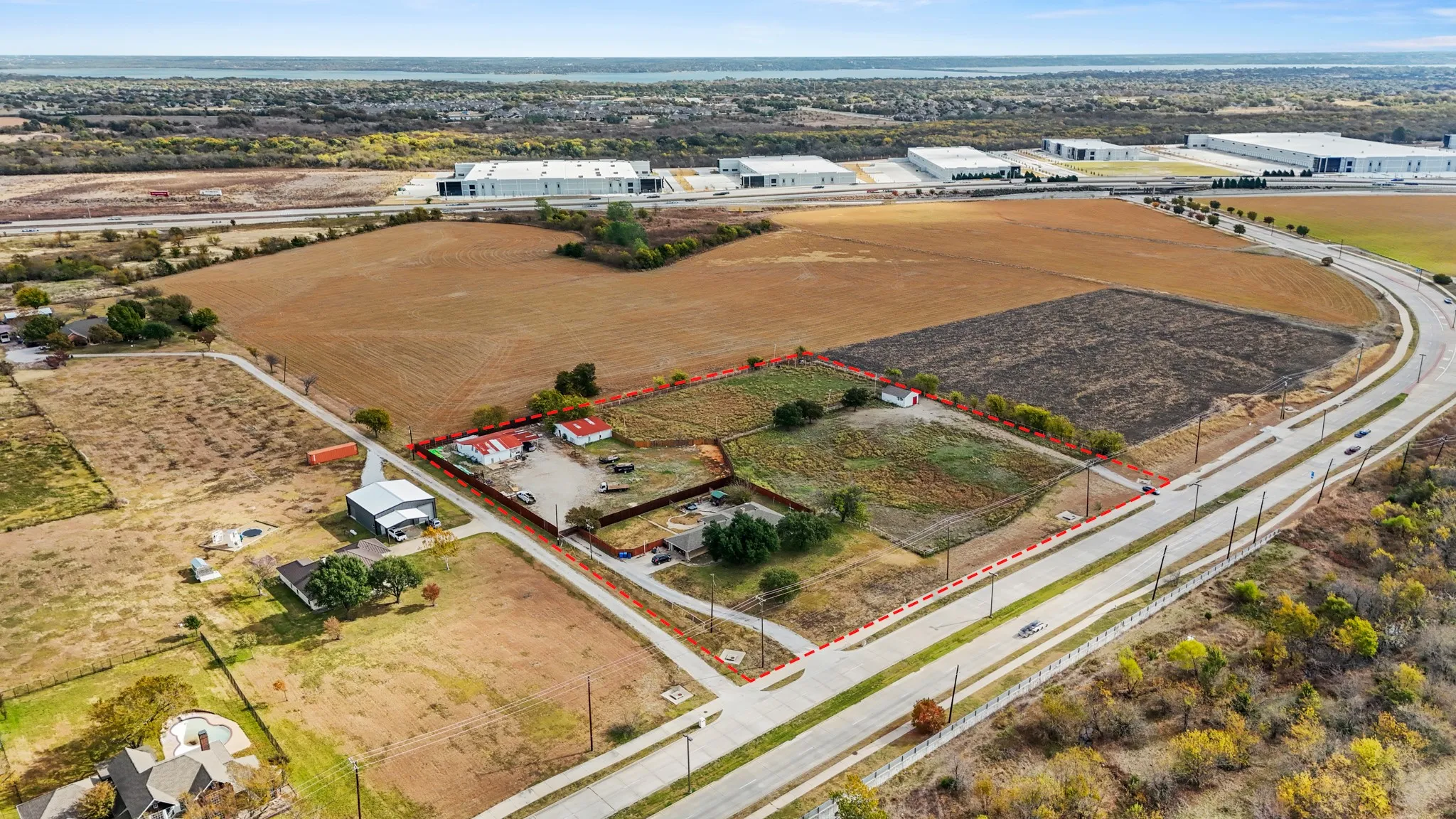 Aerial view of sparsely populated area featuring property boundaries highlighted and extensive farmland
