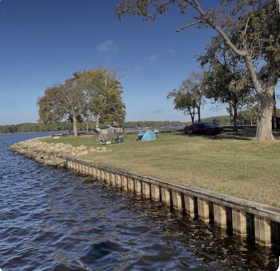 Dock area with a lawn and a water view