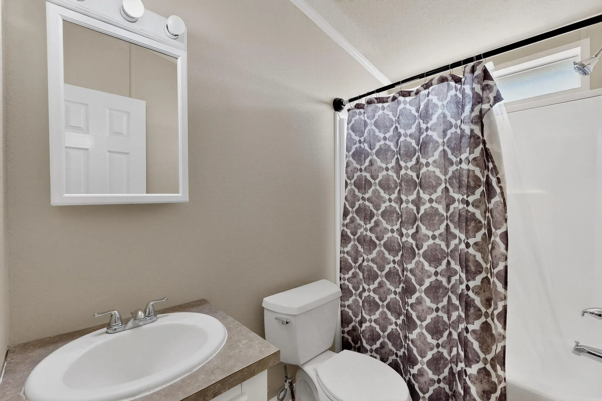 Full bath featuring vanity and shower / bath combo with shower curtain