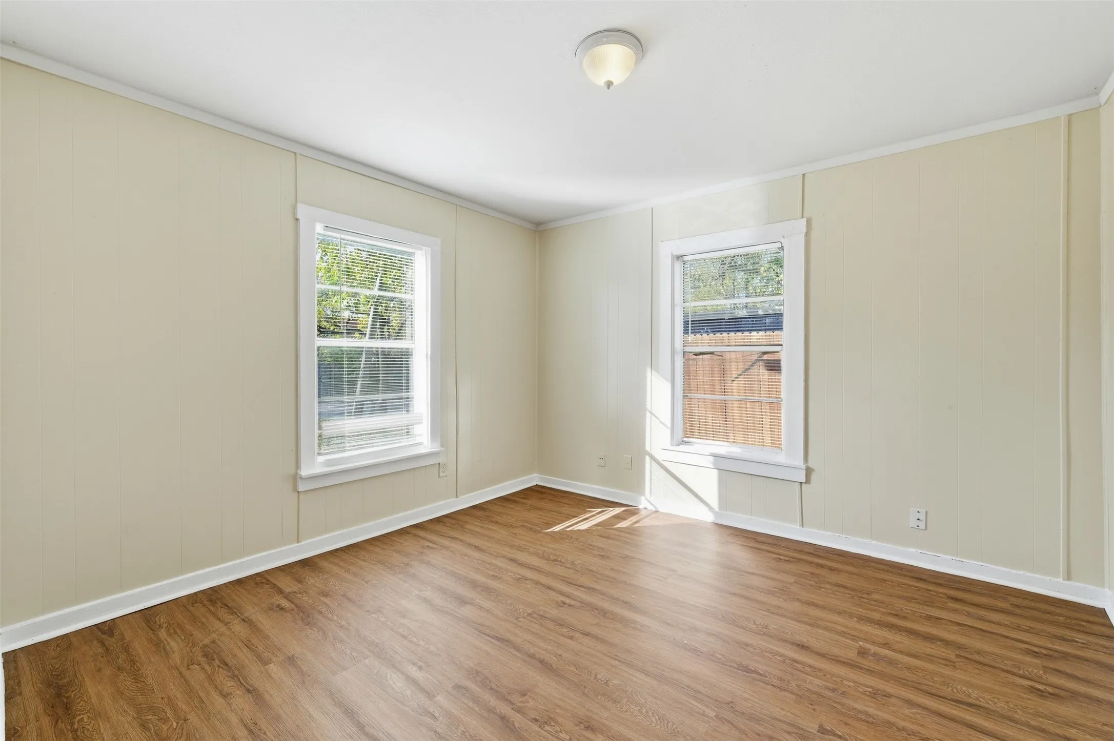 Spare room featuring wood finished floors and ornamental molding