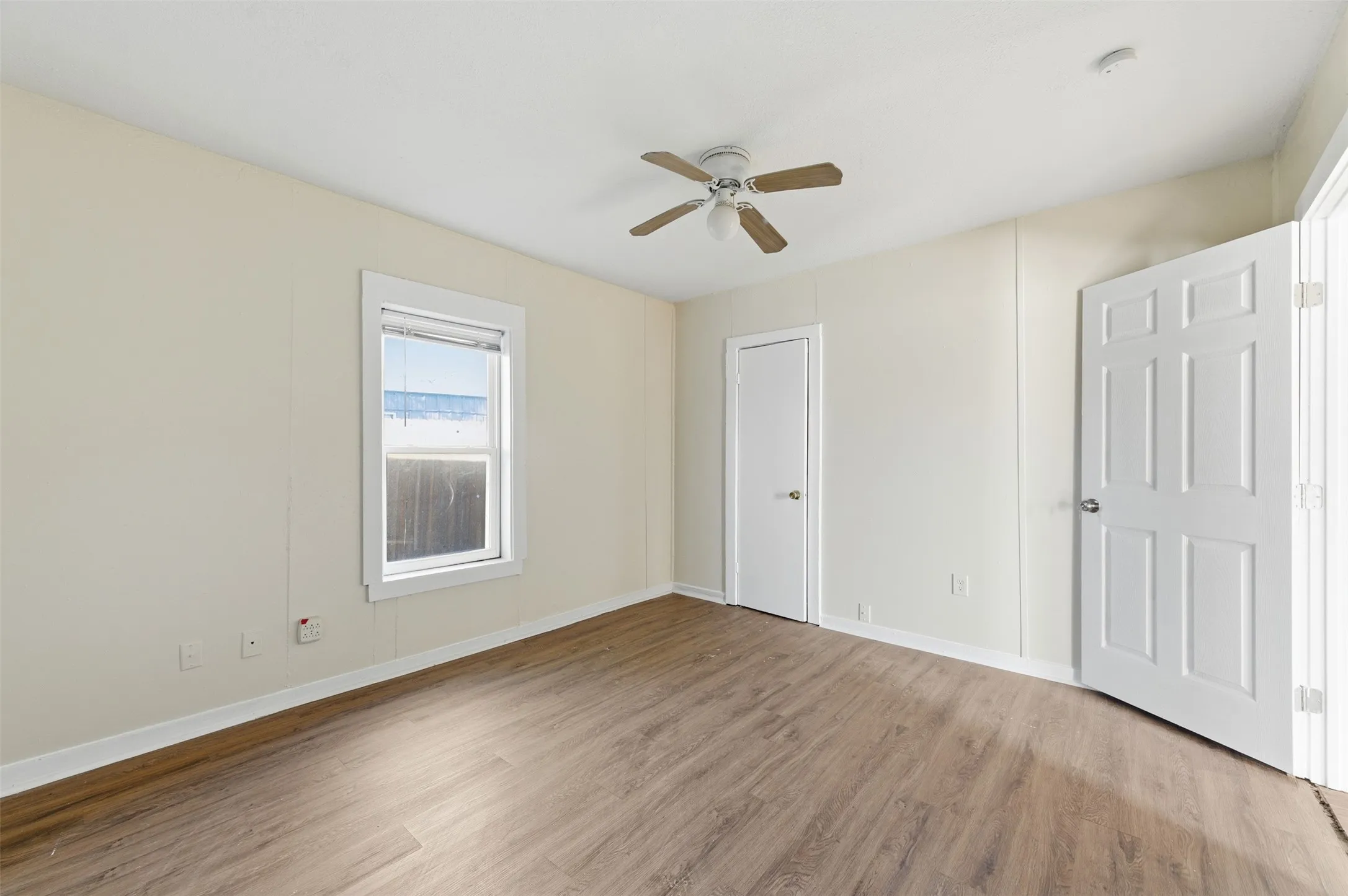 Unfurnished bedroom with light wood-style flooring and a ceiling fan