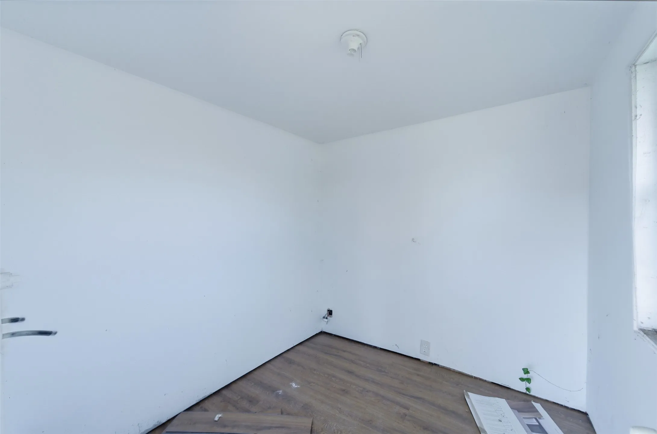 Spare room with dark wood-style flooring