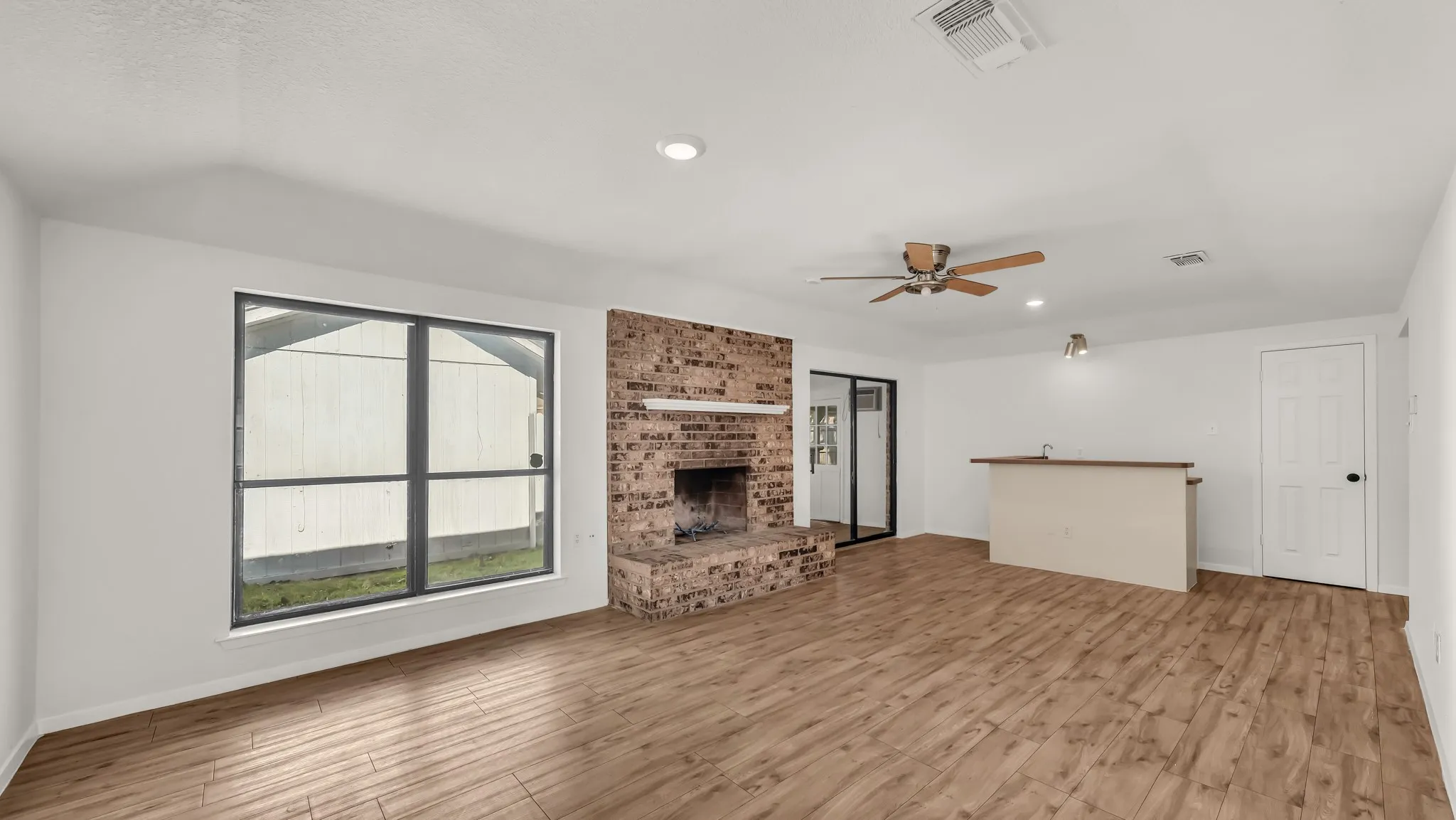 Unfurnished living room featuring recessed lighting, light wood-type flooring, and a fireplace