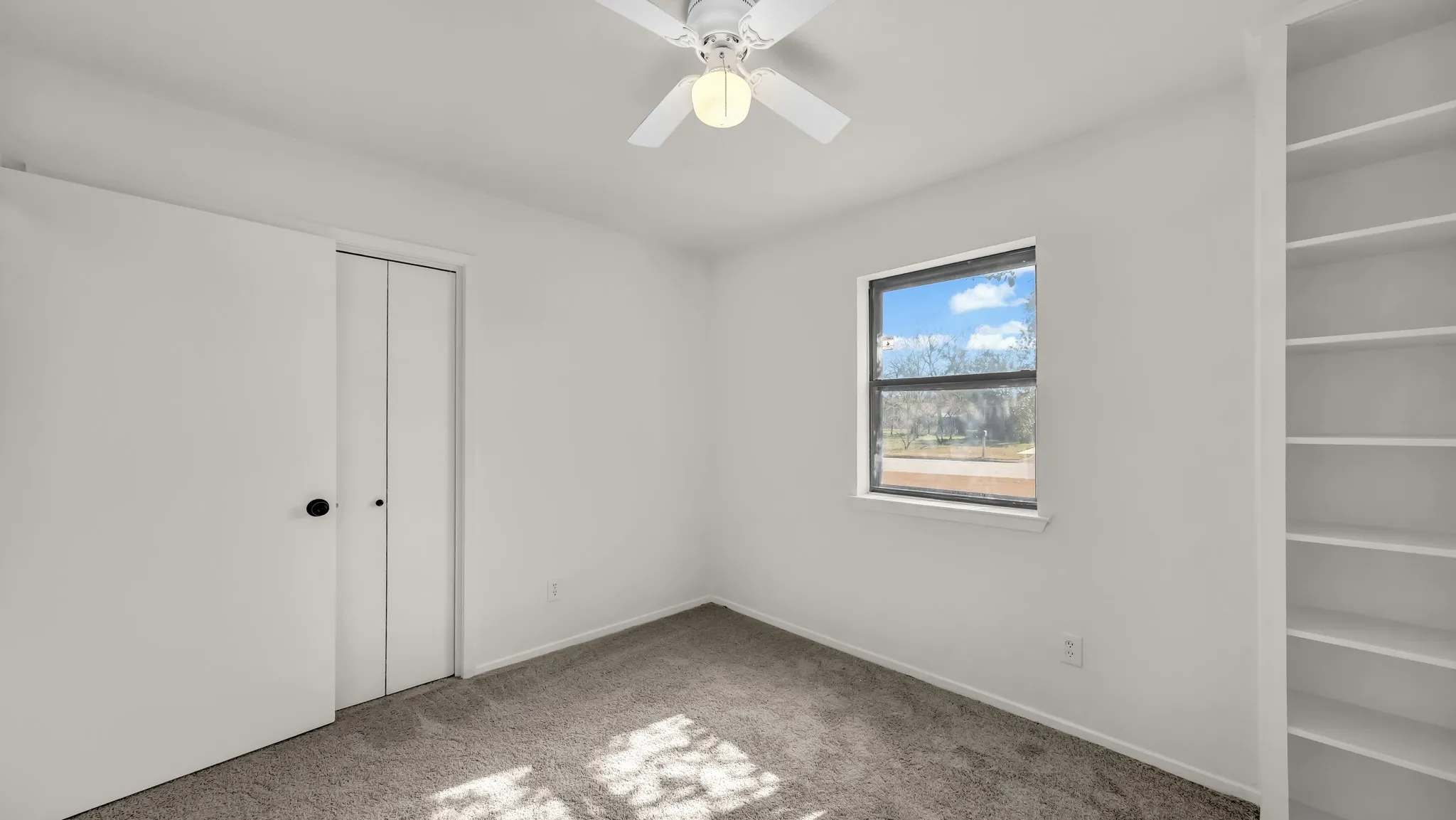 Unfurnished bedroom featuring carpet, a closet, and a ceiling fan