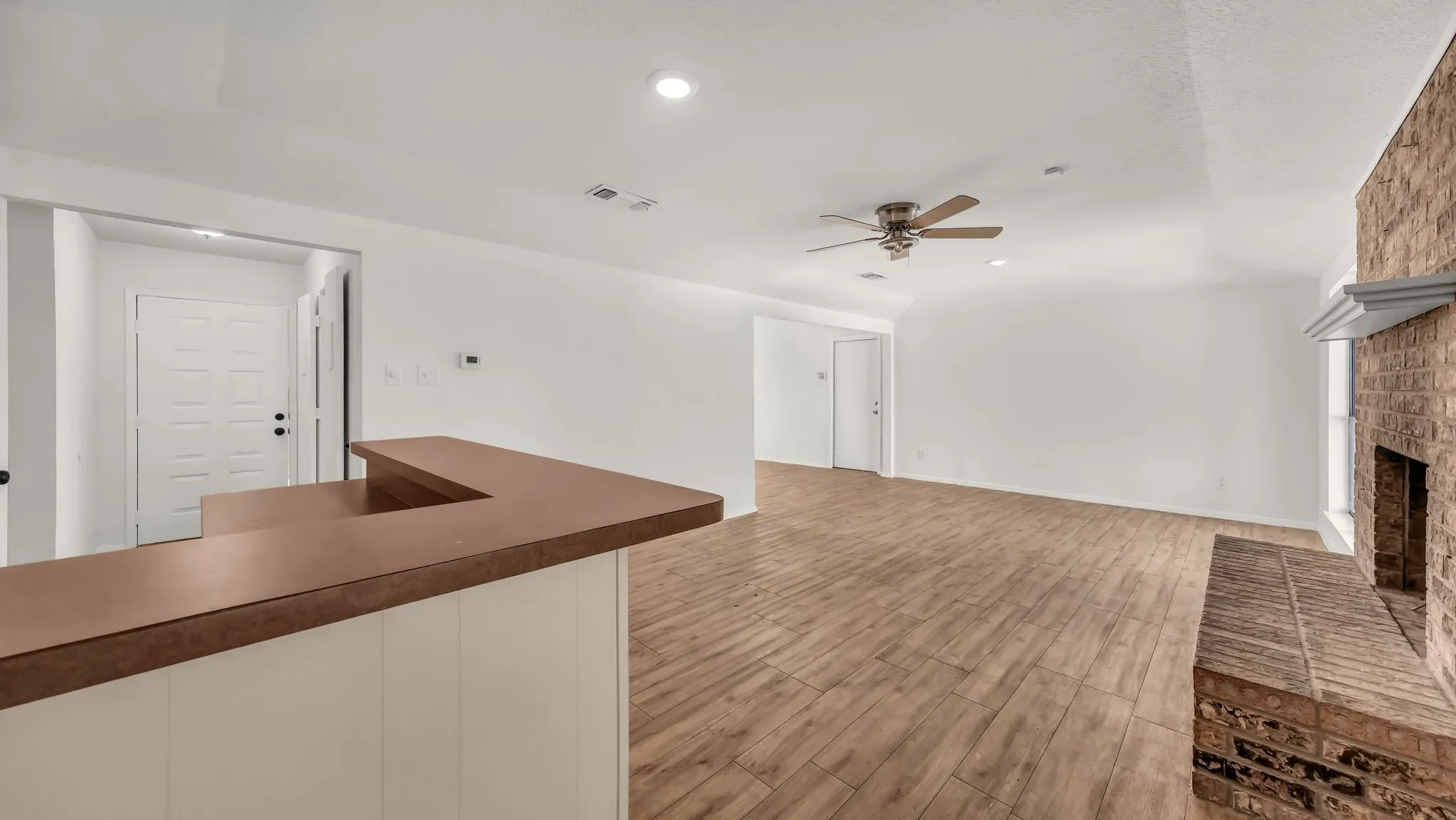 Unfurnished living room featuring light wood-style floors, a fireplace, recessed lighting, and ceiling fan