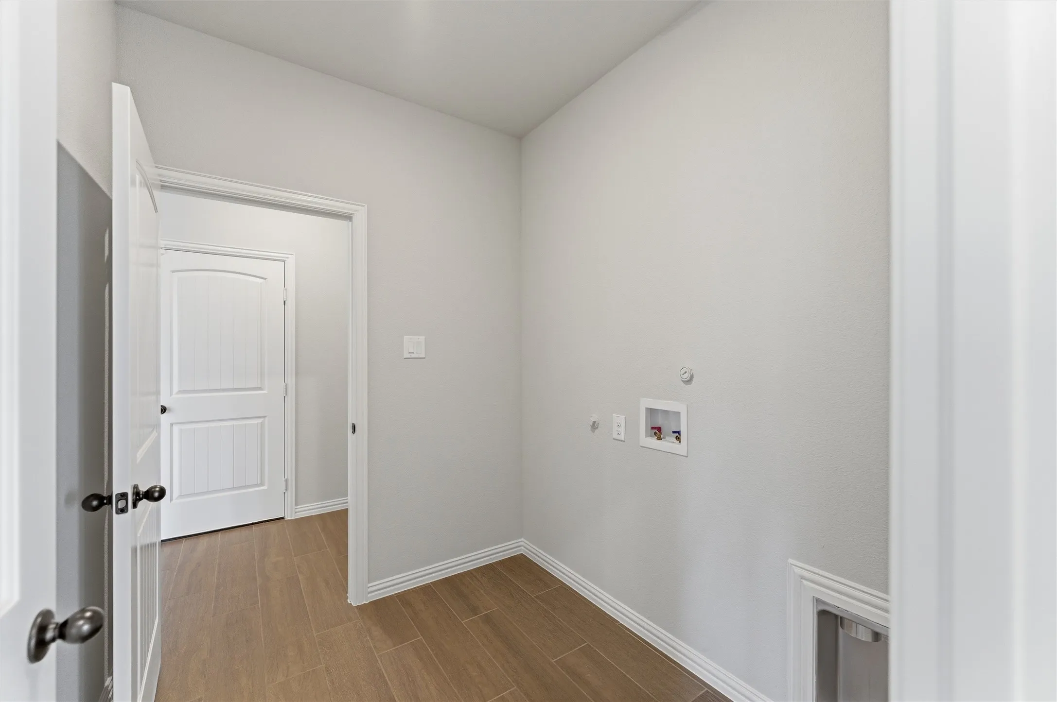 Laundry room featuring hookup for a gas dryer, washer hookup, and wood finish floors