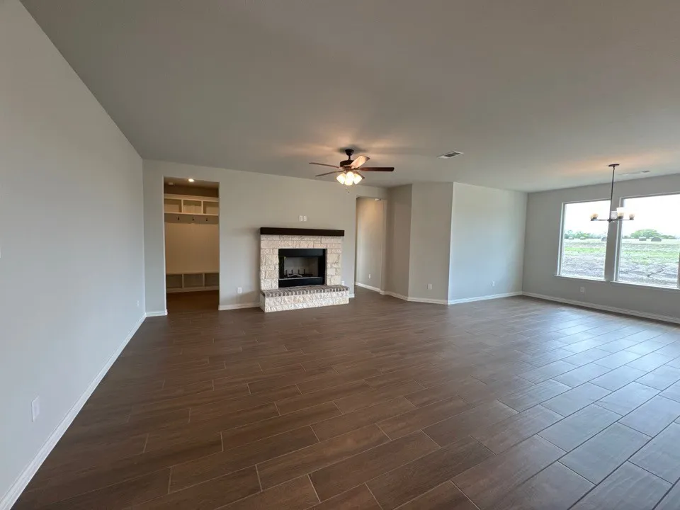 Empty room with light carpet and baseboards