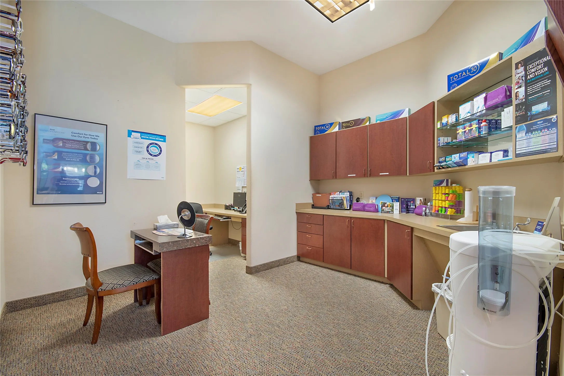 Home office featuring washer / dryer, light colored carpet, and built in desk