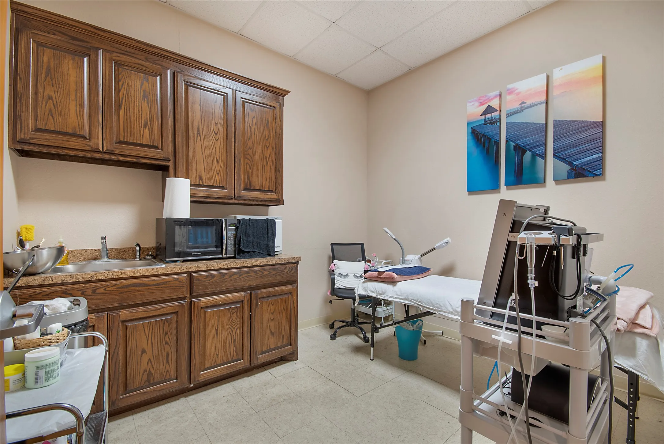 Office area with a drop ceiling and a sink