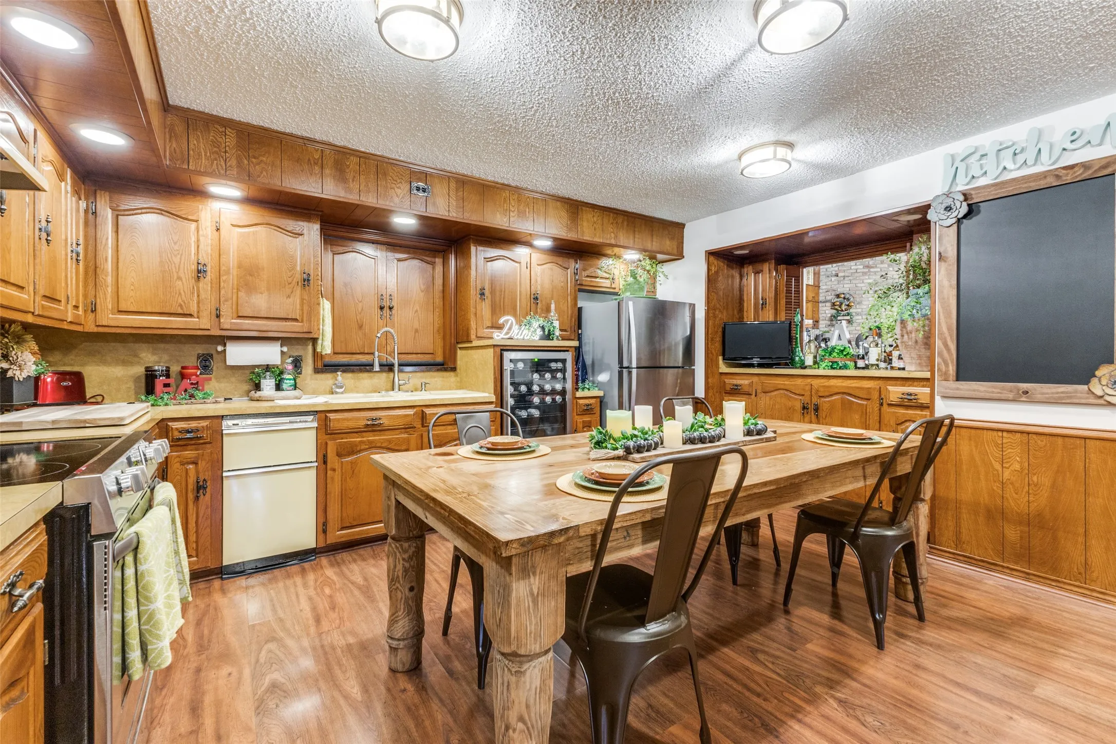 Kitchen has plenty of room for informal dining plus built in buffet-style cabinets under the window.