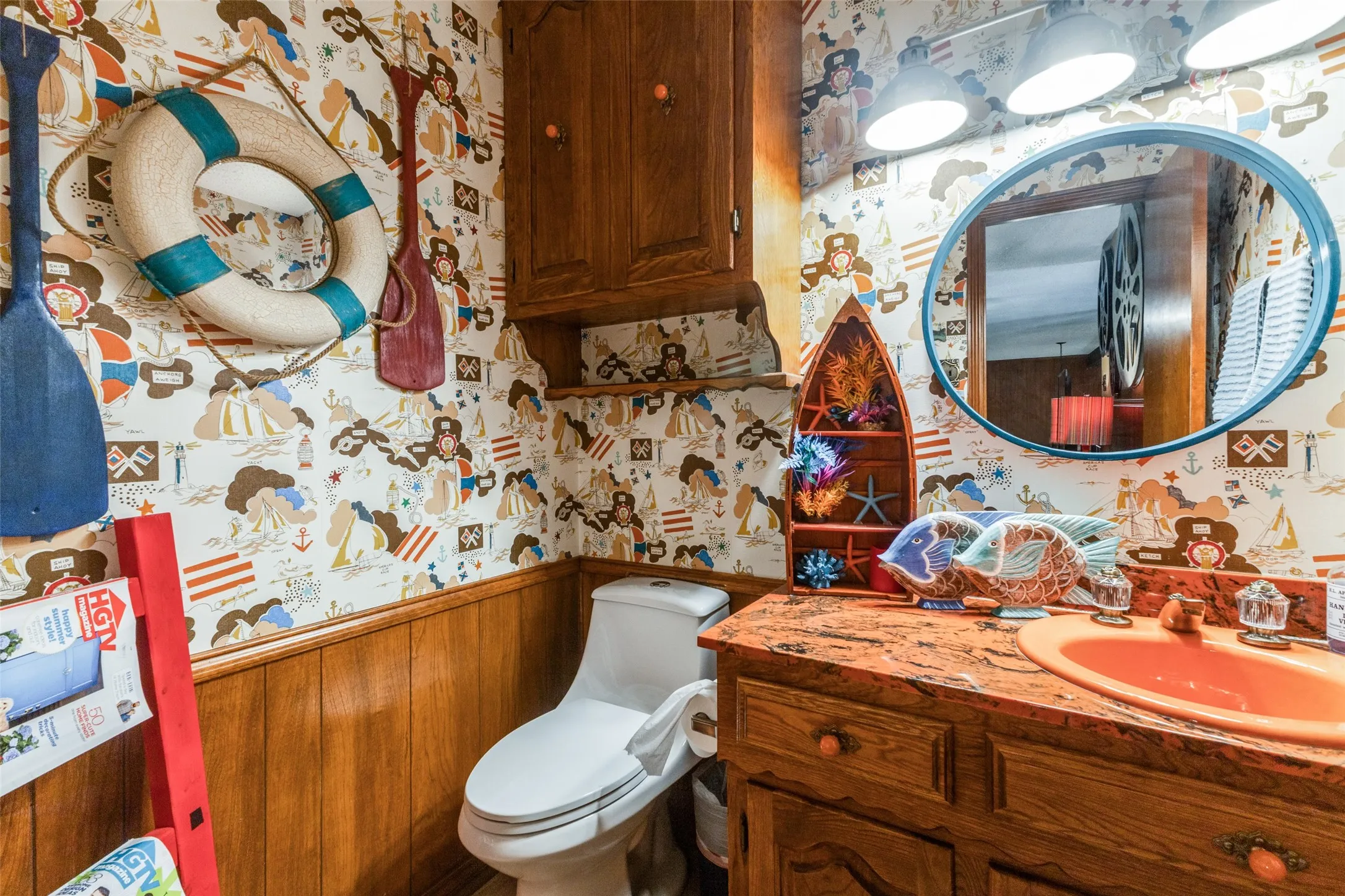 Bathroom featuring wallpapered walls, a wainscoted wall, vanity, and wood walls