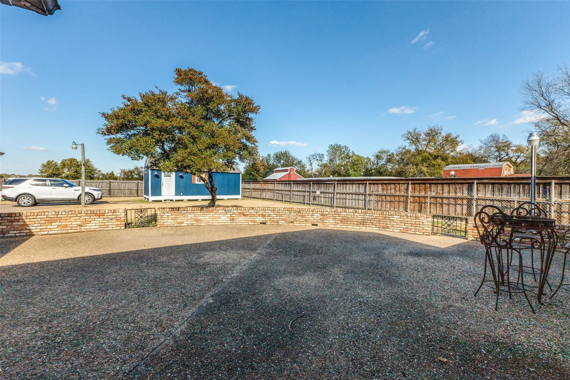Fenced backyard with an outdoor structure