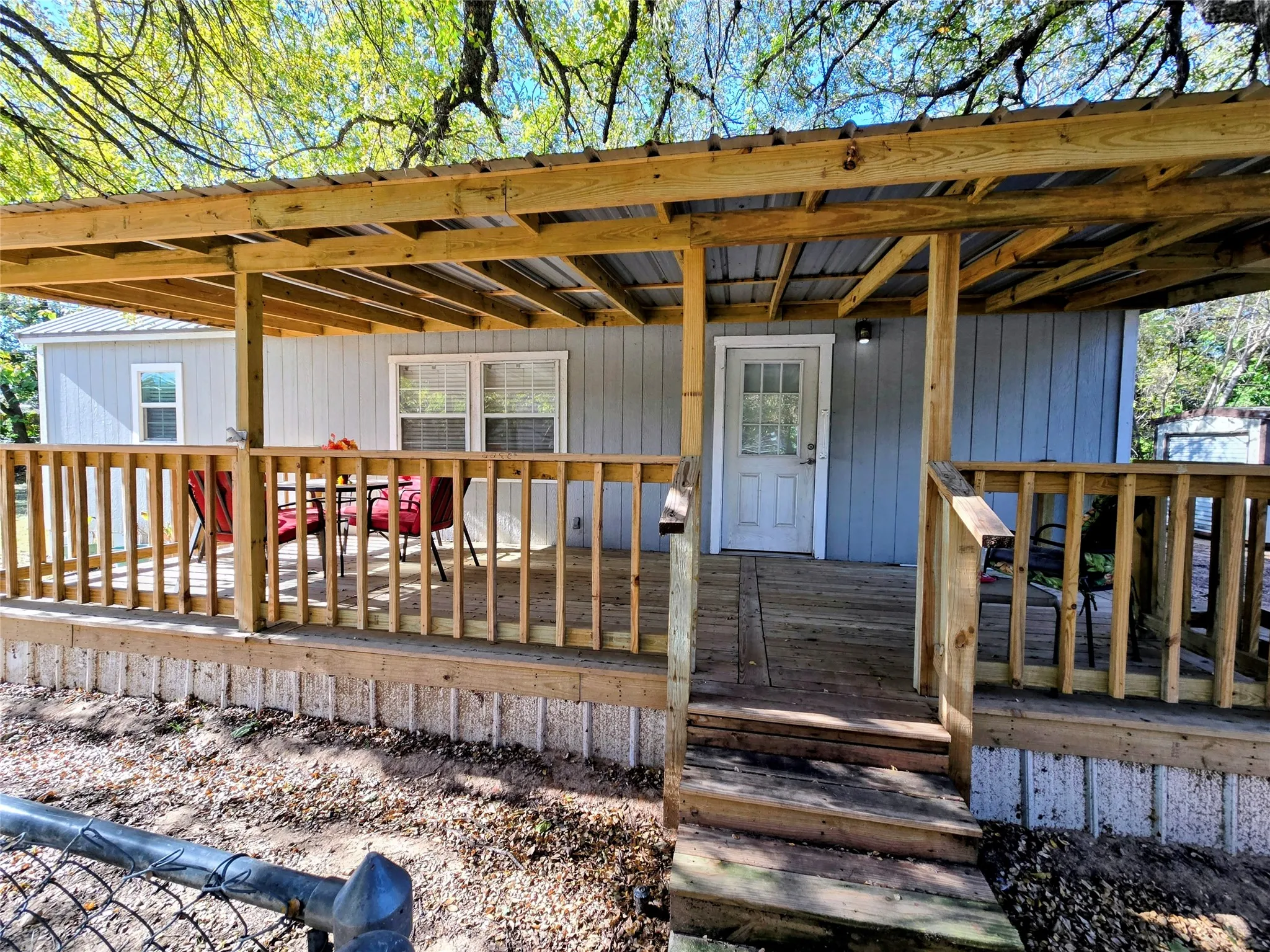 View of exterior entry with a deck