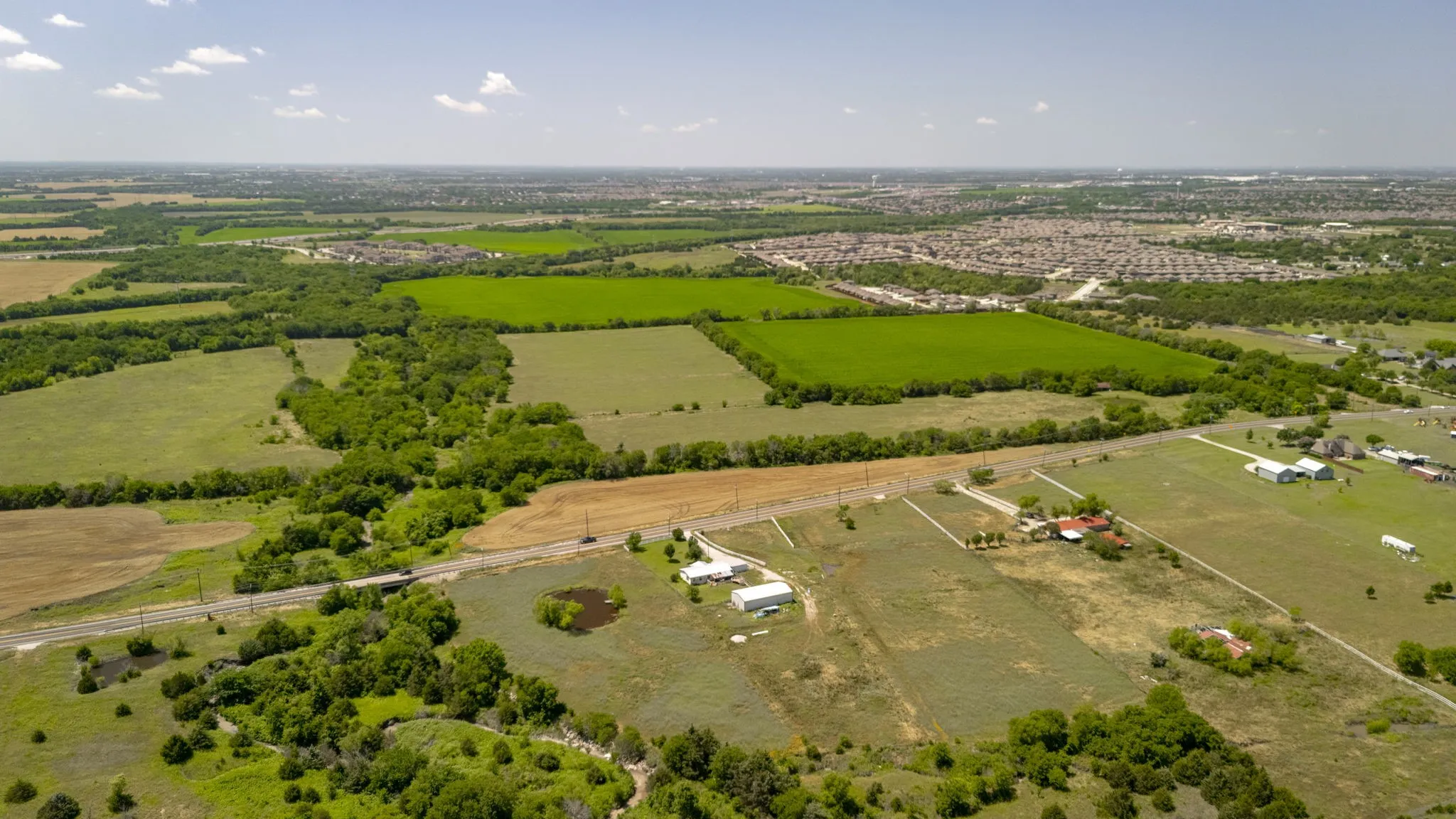 Aerial overview of property's location with rural landscape and abundant farmland