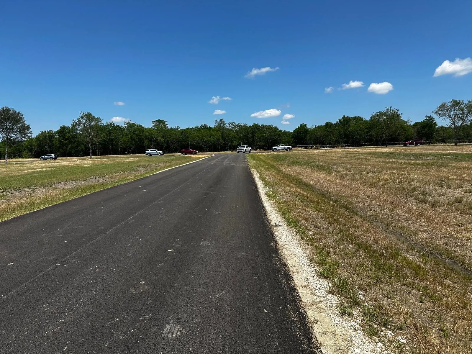 View of asphalt street with a rural view