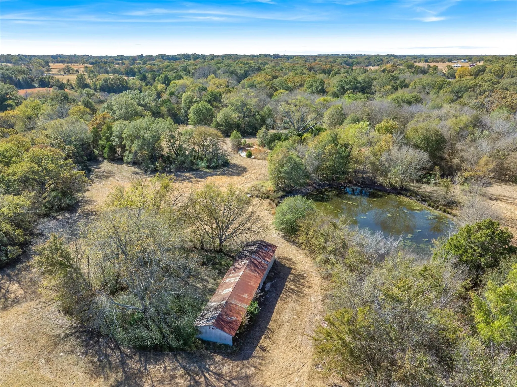 Old Barn and small shed with fenced area, from Days of Emory Archery Club overlooking pond