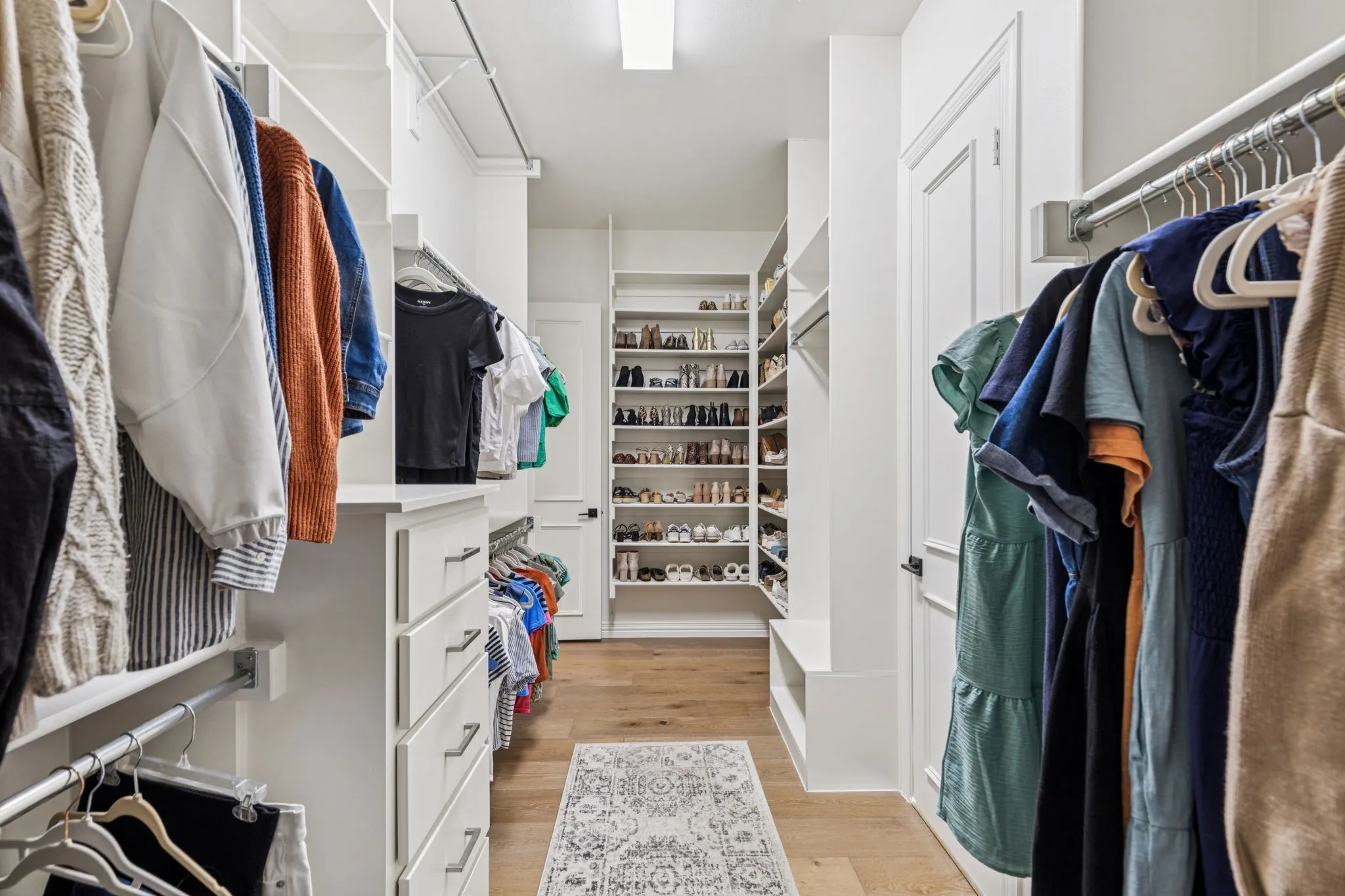 Walk in closet featuring light wood-type flooring
