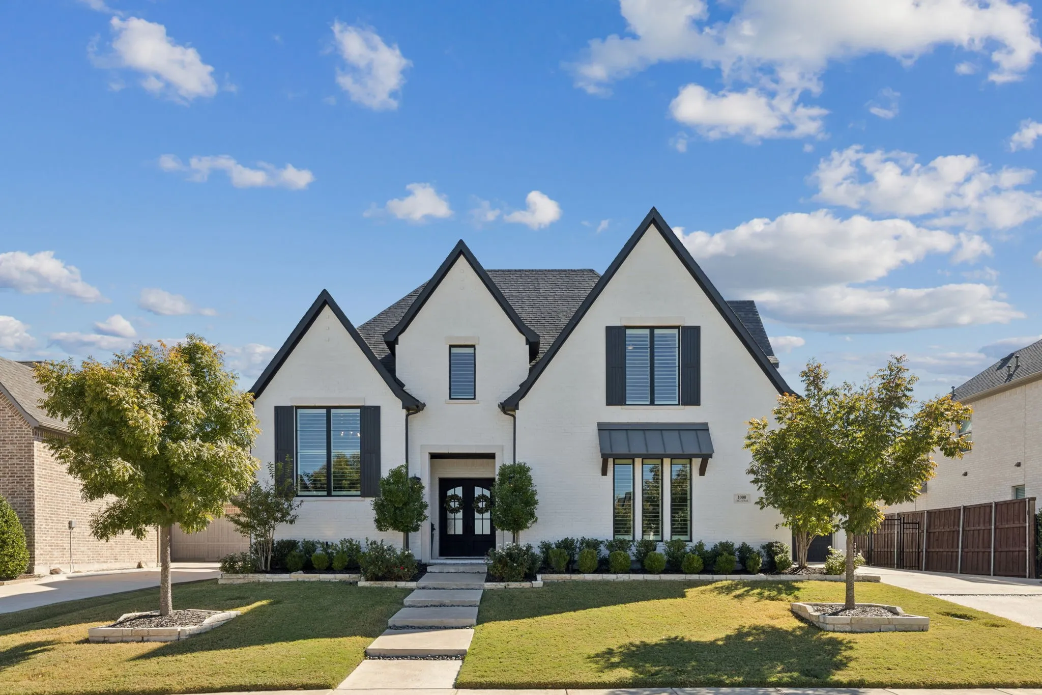 View of front of home featuring a standing seam roof and stucco siding