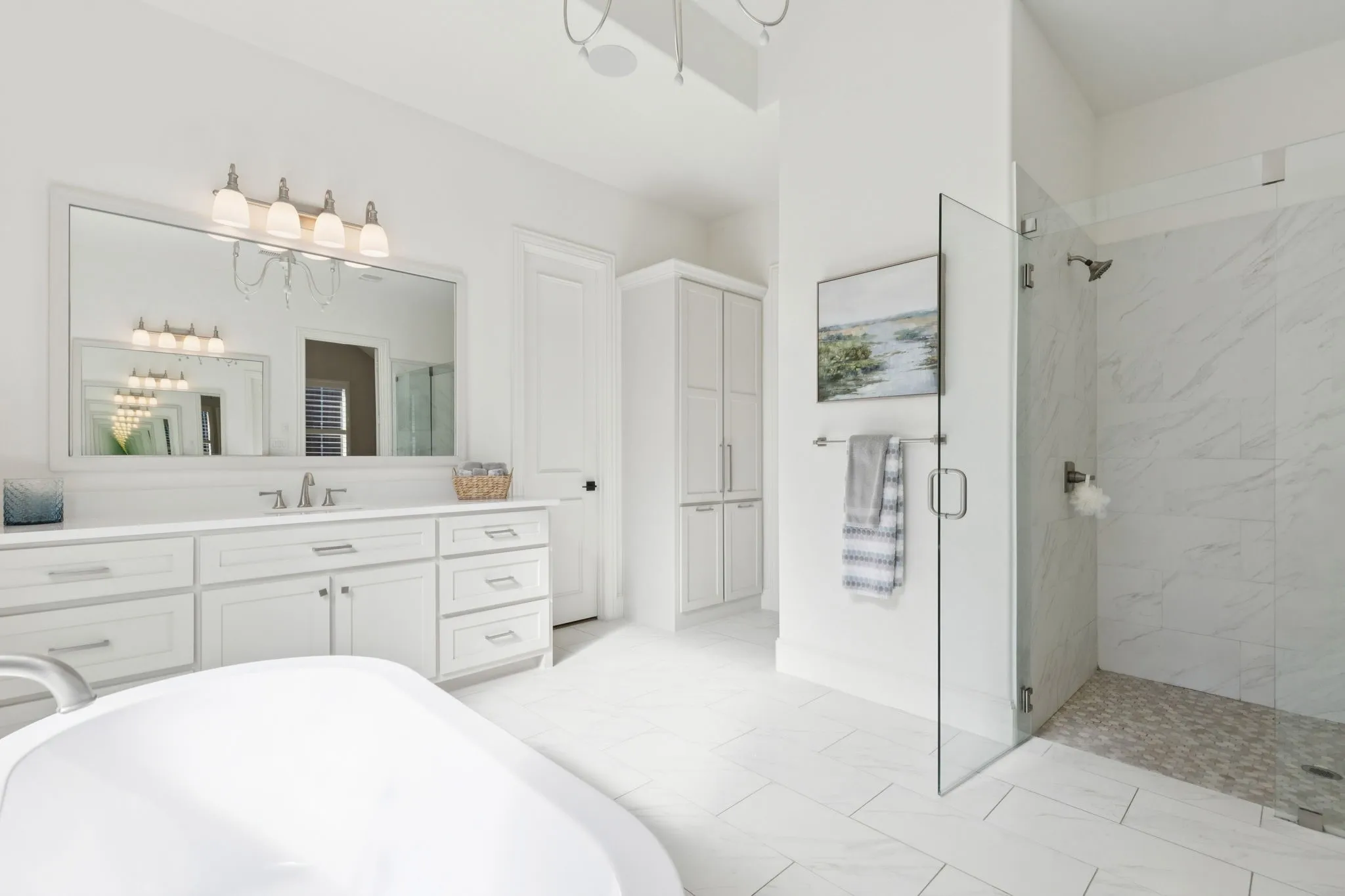 Full bath with vanity, a soaking tub, and a marble finish shower